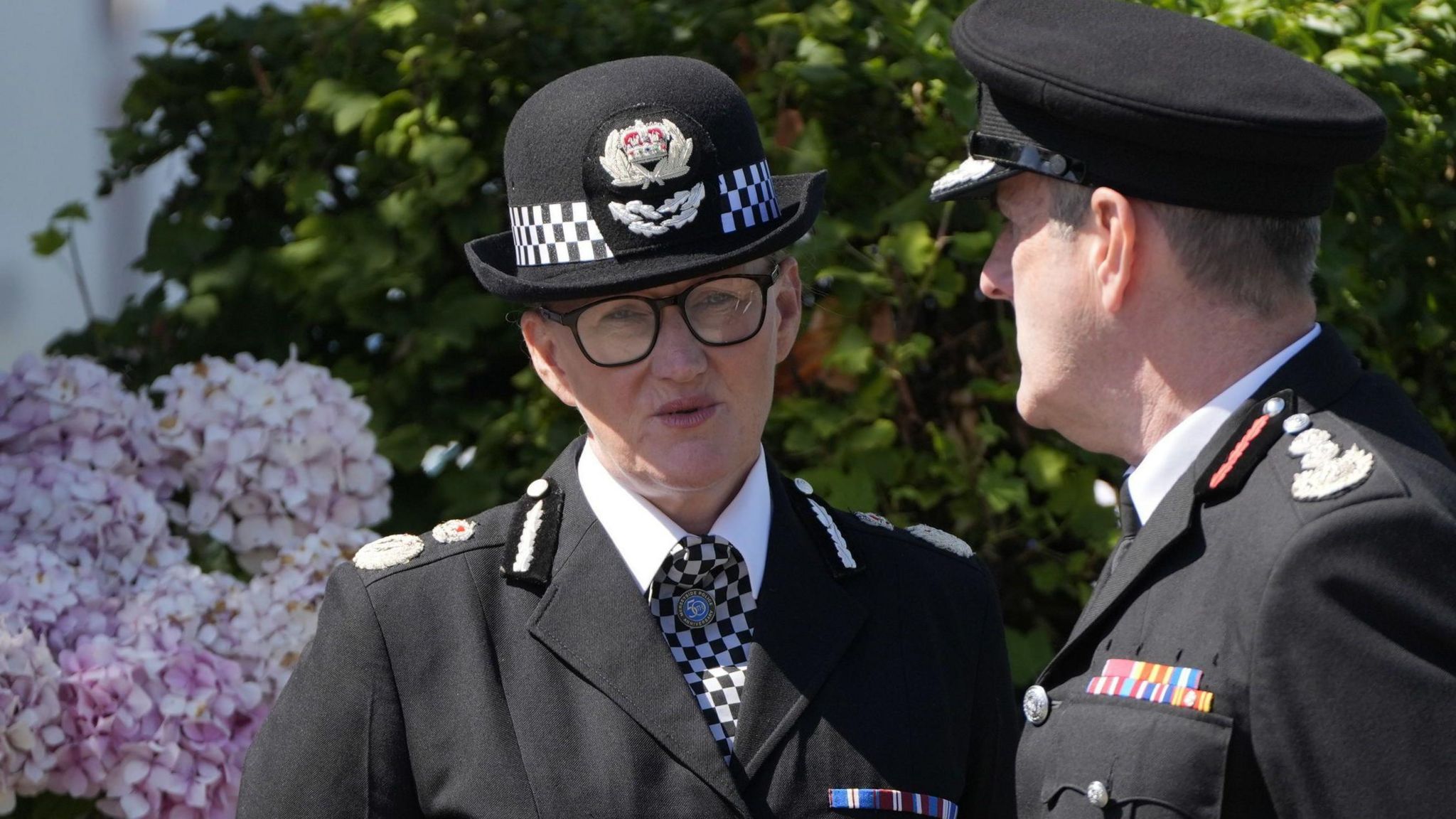 Chief constable Serena Kennedy speaking to a colleague outside the church