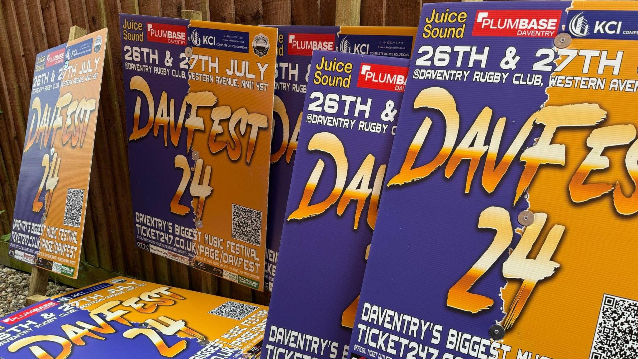 Blue and orange signs piled up in a shed 