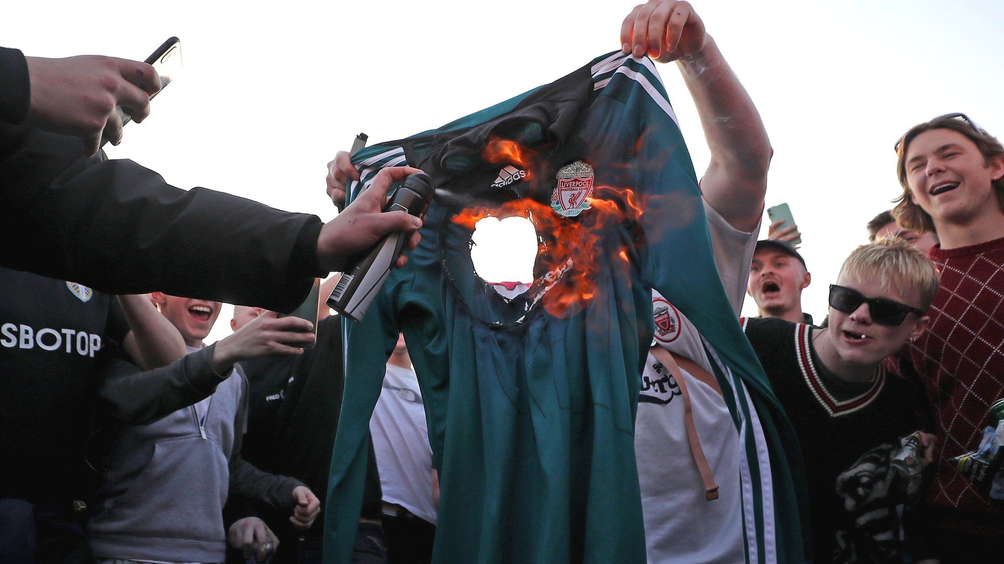 Fans burn a Liverpool shirt outside Elland Road