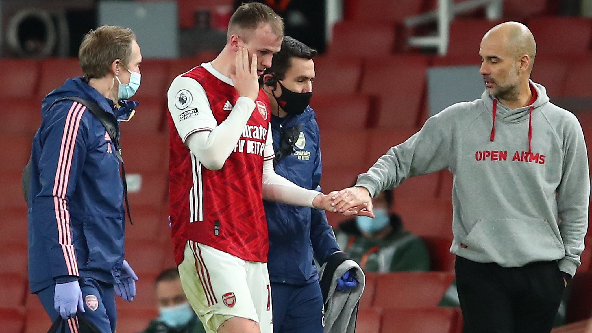 Arsenal's Rob Holding with Manchester City manager Pep Guardiola