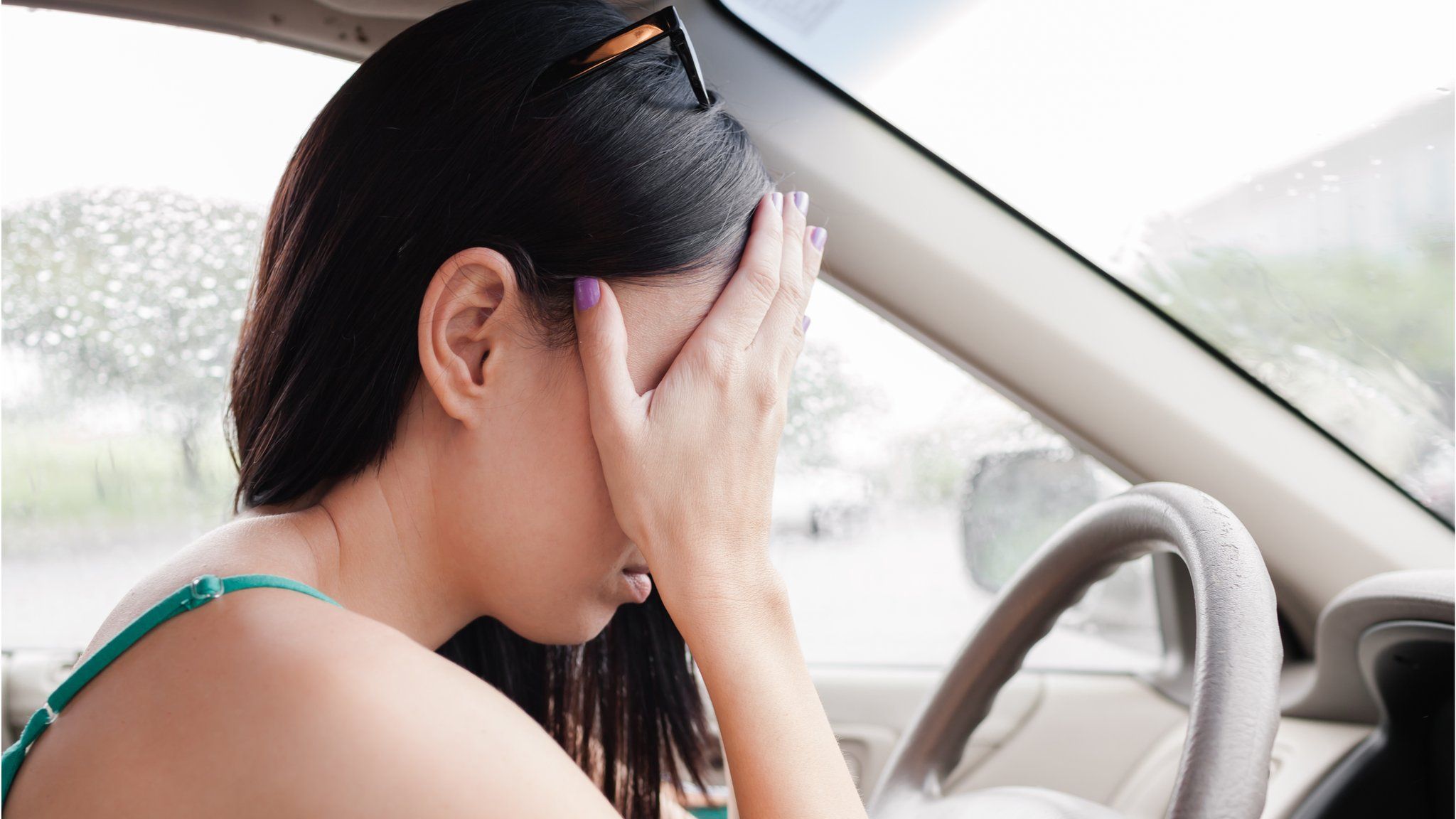 Woman despairing while driving