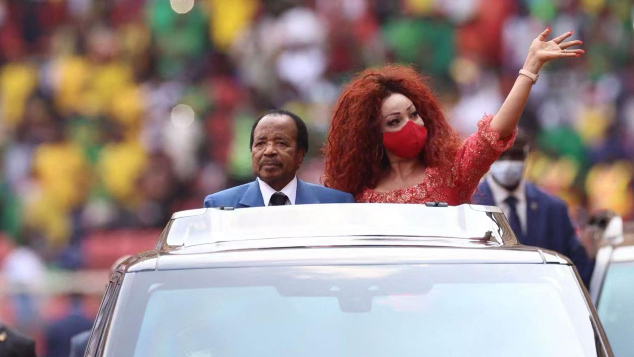 Cameroon's President Paul Biya and First Lady Chantal Biya wave at the crowd from a car during the opening ceremony of the 2021 Africa Cup of Nations 