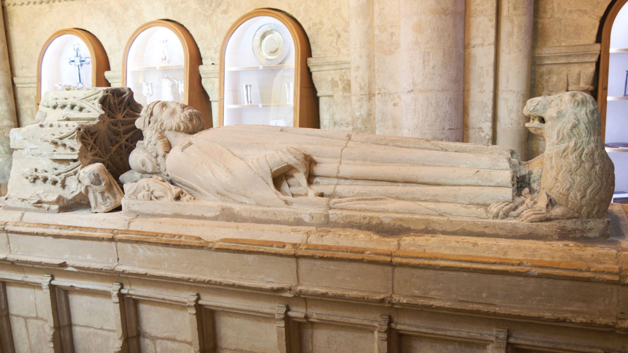 The tomb of King Athelstan in Malmesbury Abbey with a sculpture of the king on top.