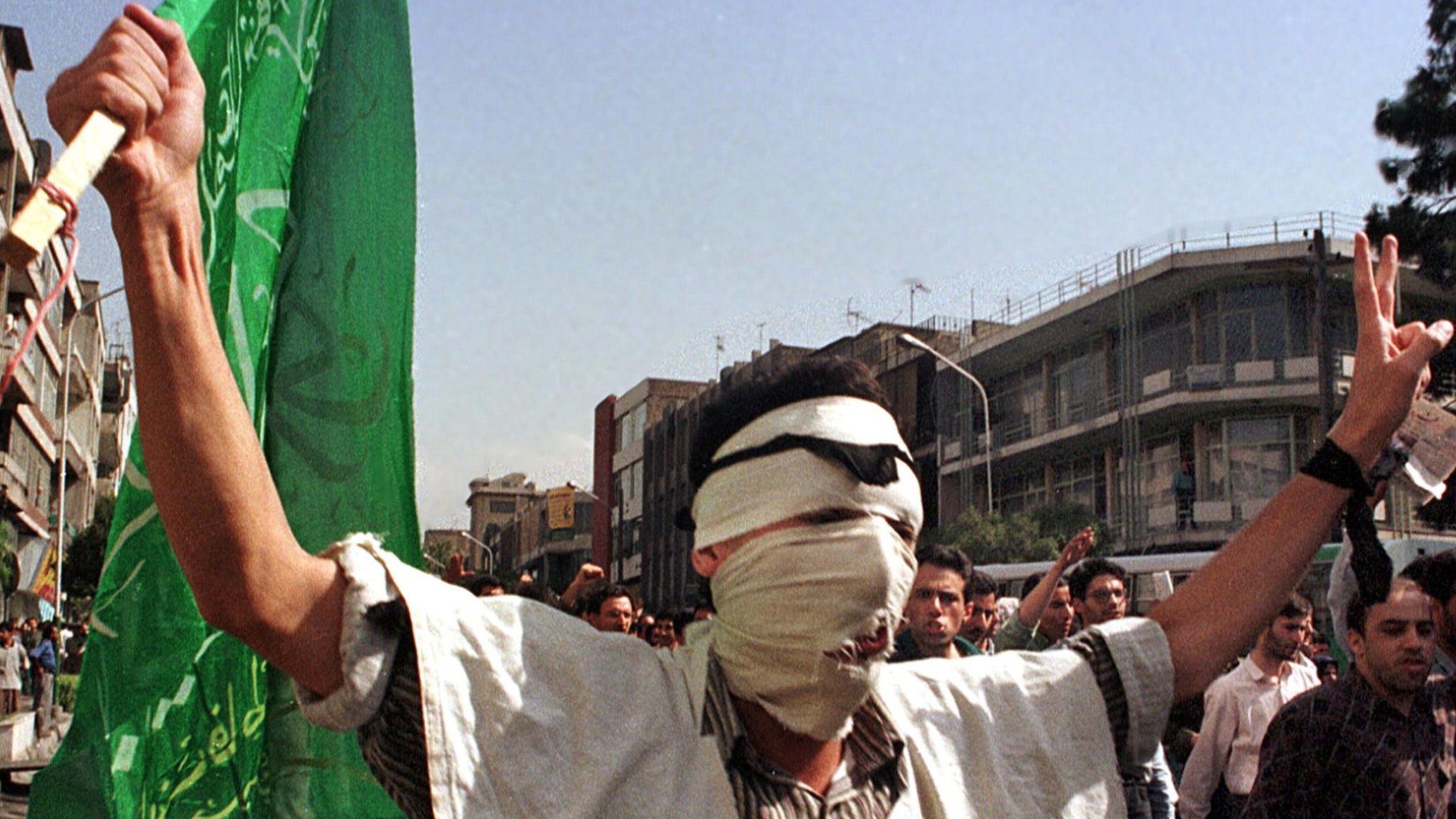 An Iranian student demonstrates in the center of Tehran during new protests, 10 July 1999, following overnight fierce clashes on the campus of Tehran Univesrity. Iranian papers said three people were killed and two wounded during the 09 July 1999 clashes between police and students over the closure of leftist daily Salam. (Photo credit should read ATTA KENARE/AFP/Getty Images)