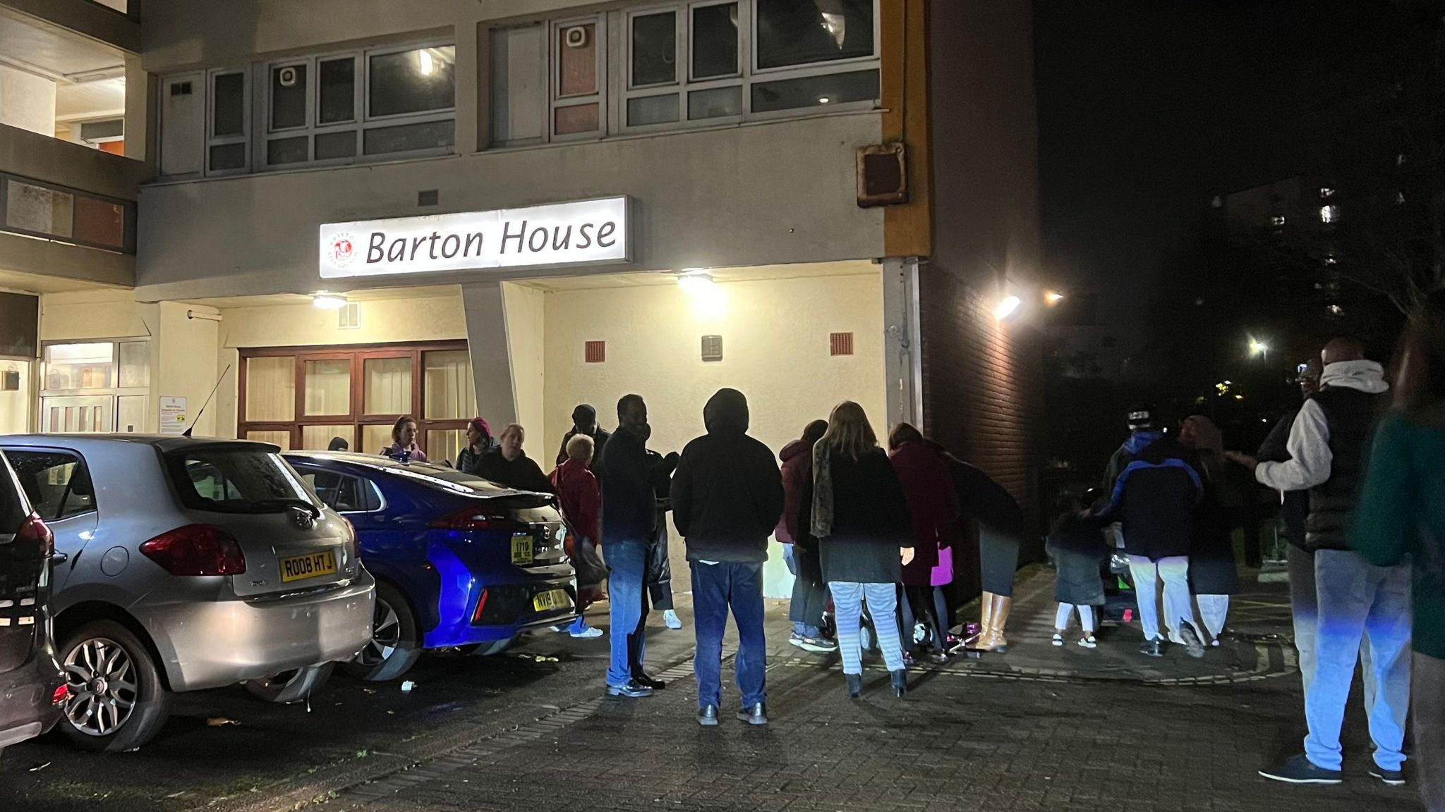 Image of residents being evacuated from Barton House on the night of 14 November