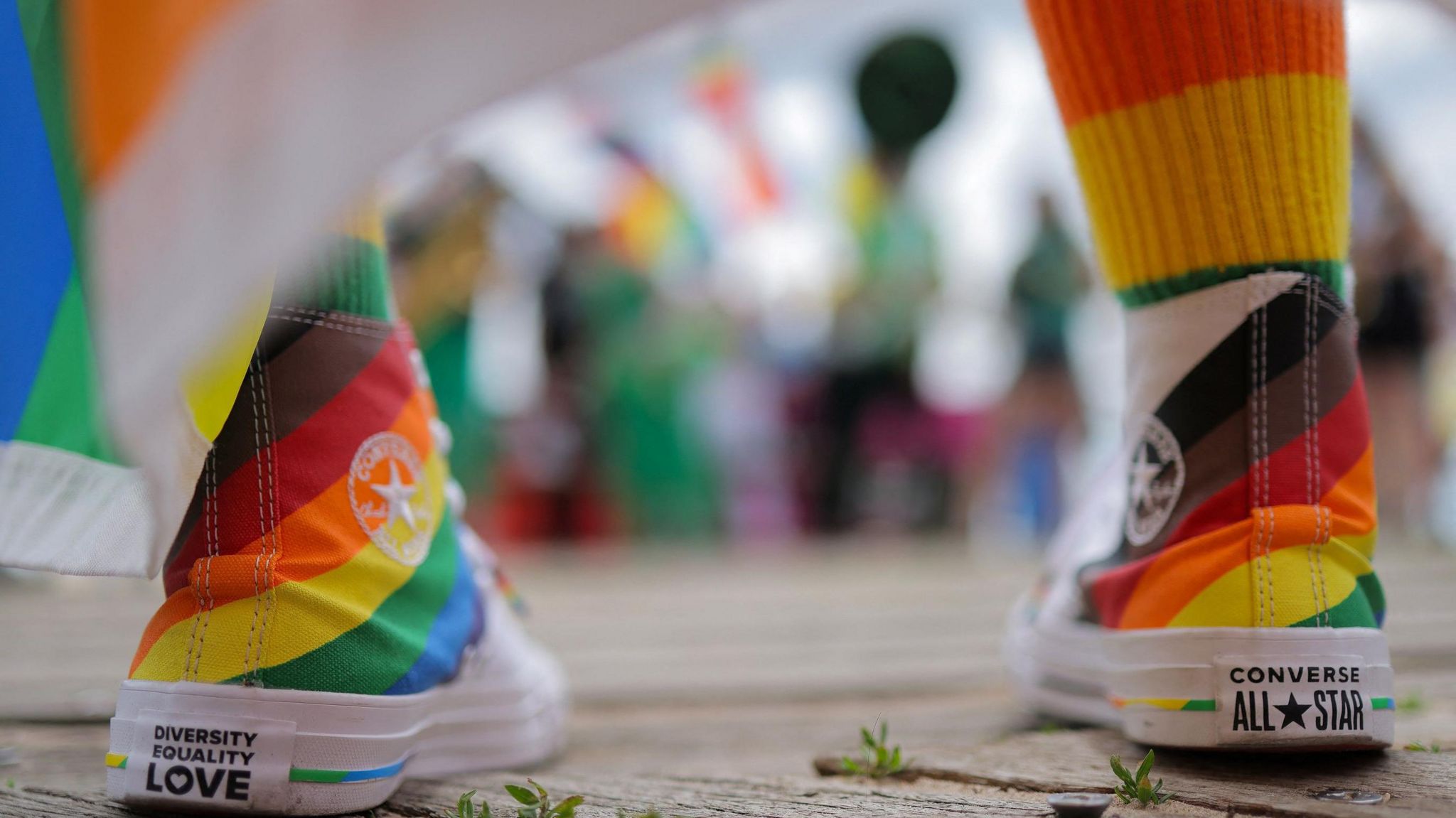 Rainbow trainers with the written words 'Diversity equality love'