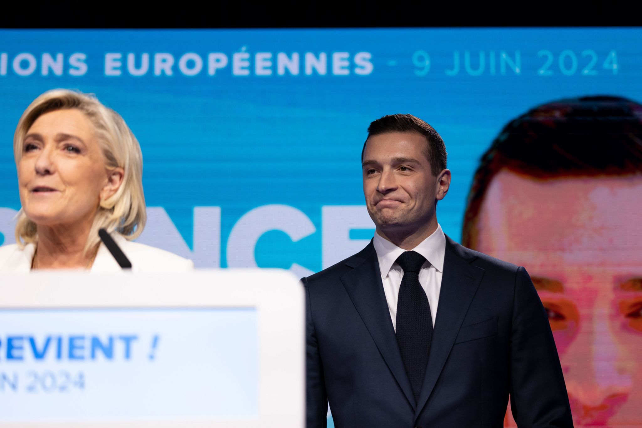 ational Rally leader Jordan Bardella (R) reacts as parliamentary party leader Marine Le Pen (L) delivers a speech at the electoral party of the French right-wing party National Rally (Rassemblement National or RN) in Paris