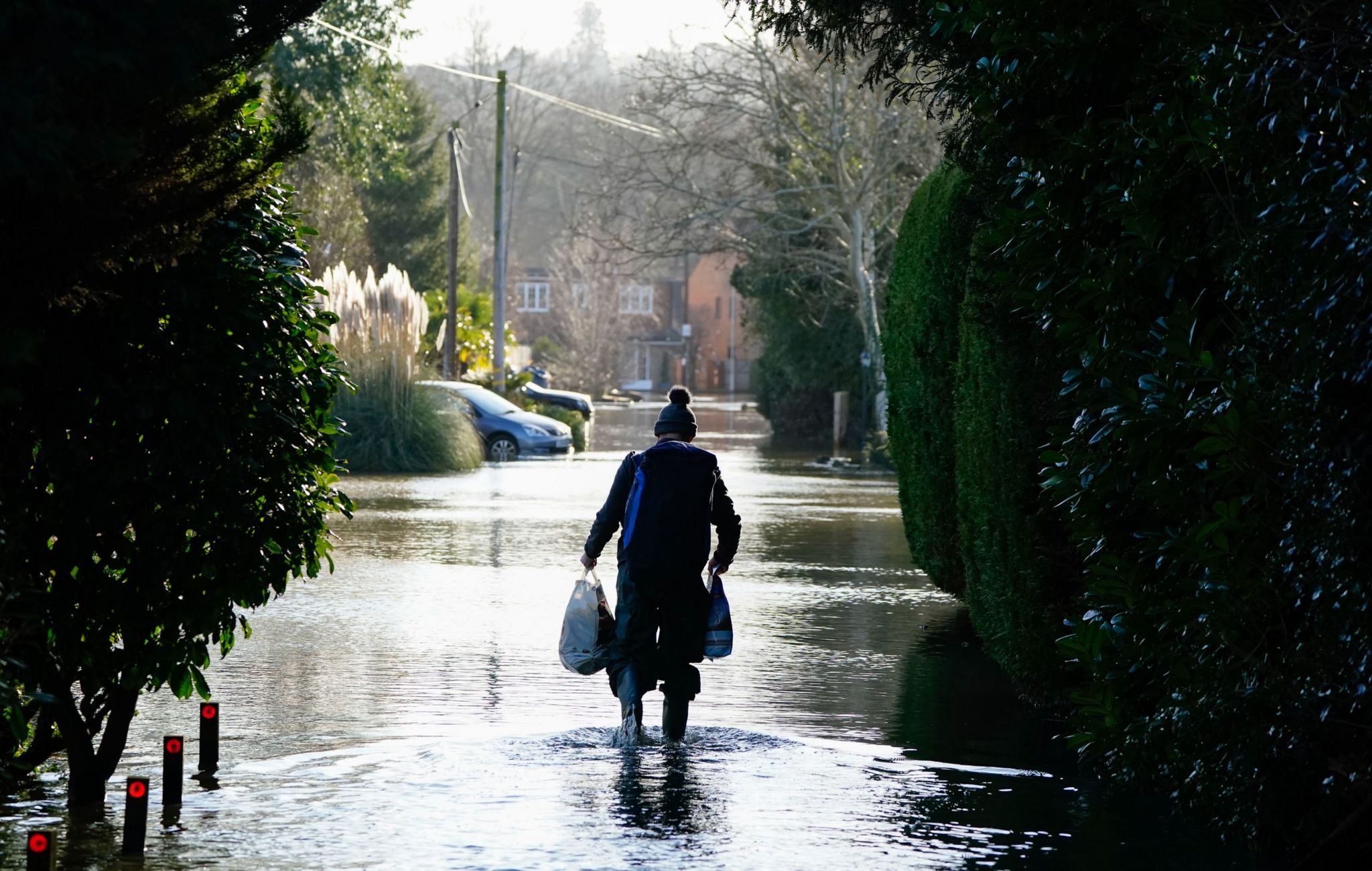 A man walks through floodwaters