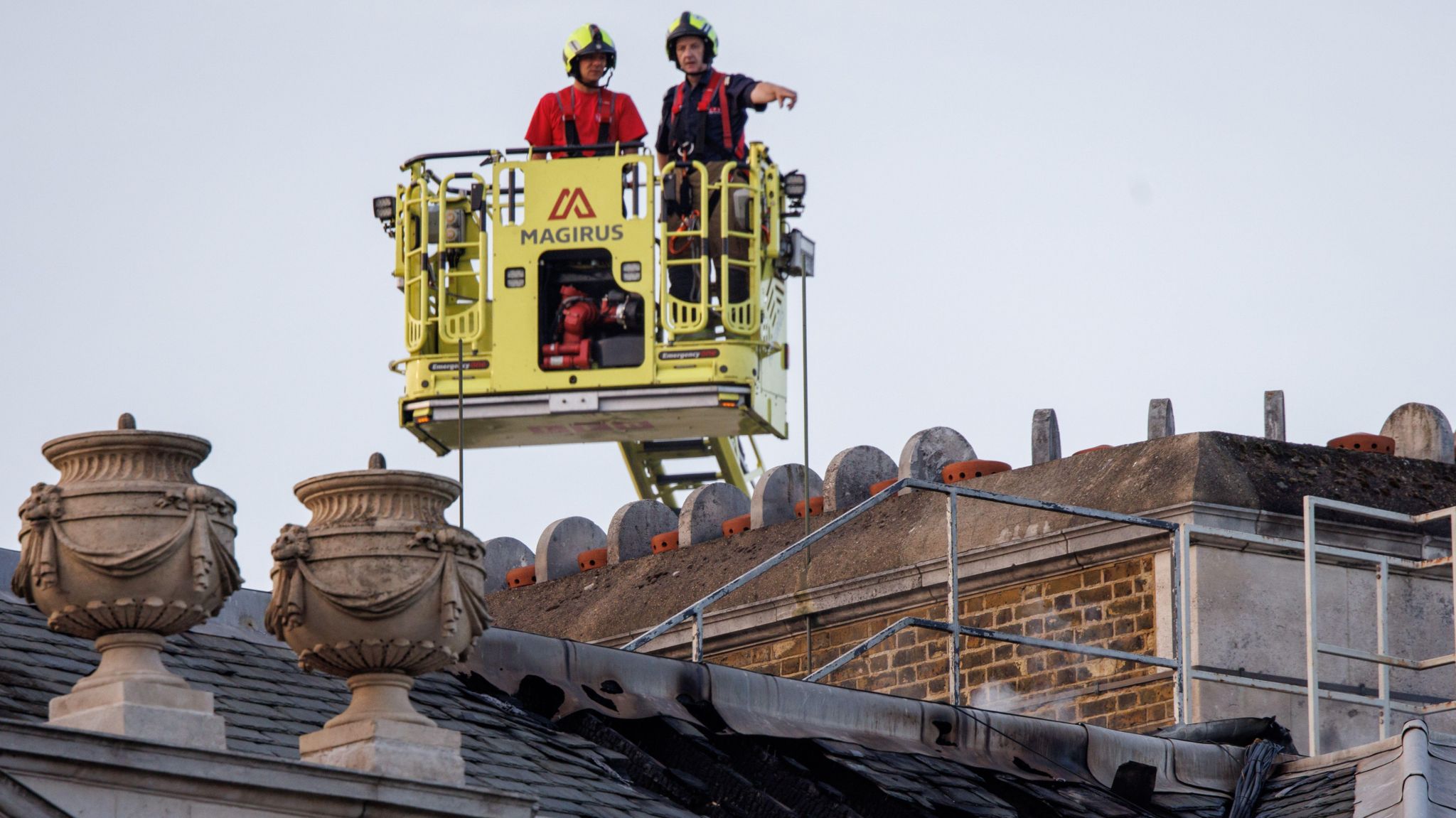 Firefighters survey the roof of Somerset House