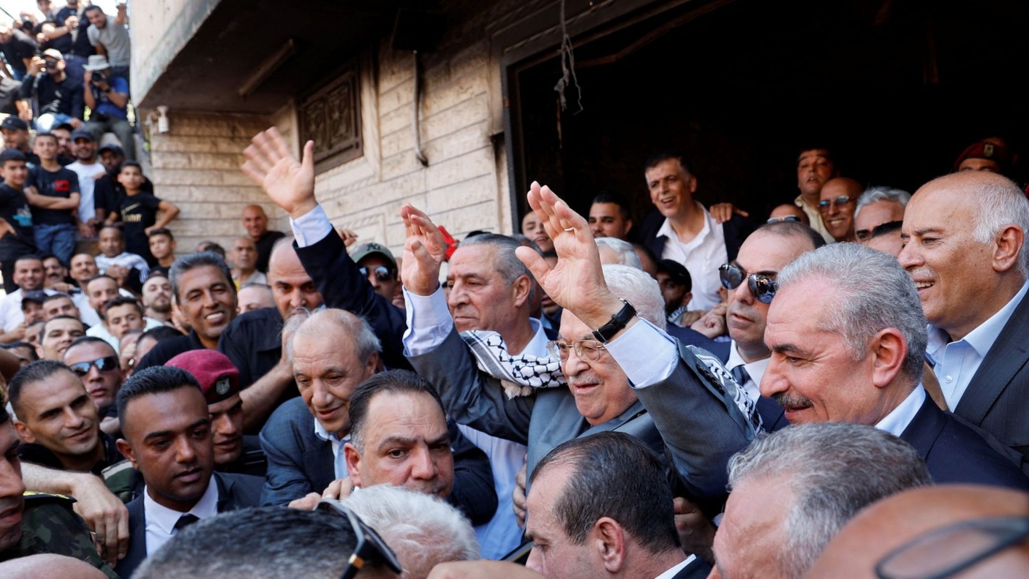 Palestinian President Mahmoud Abbas waves during a visit to Jenin refugee camp, in the occupied West Bank (12 July 2023)