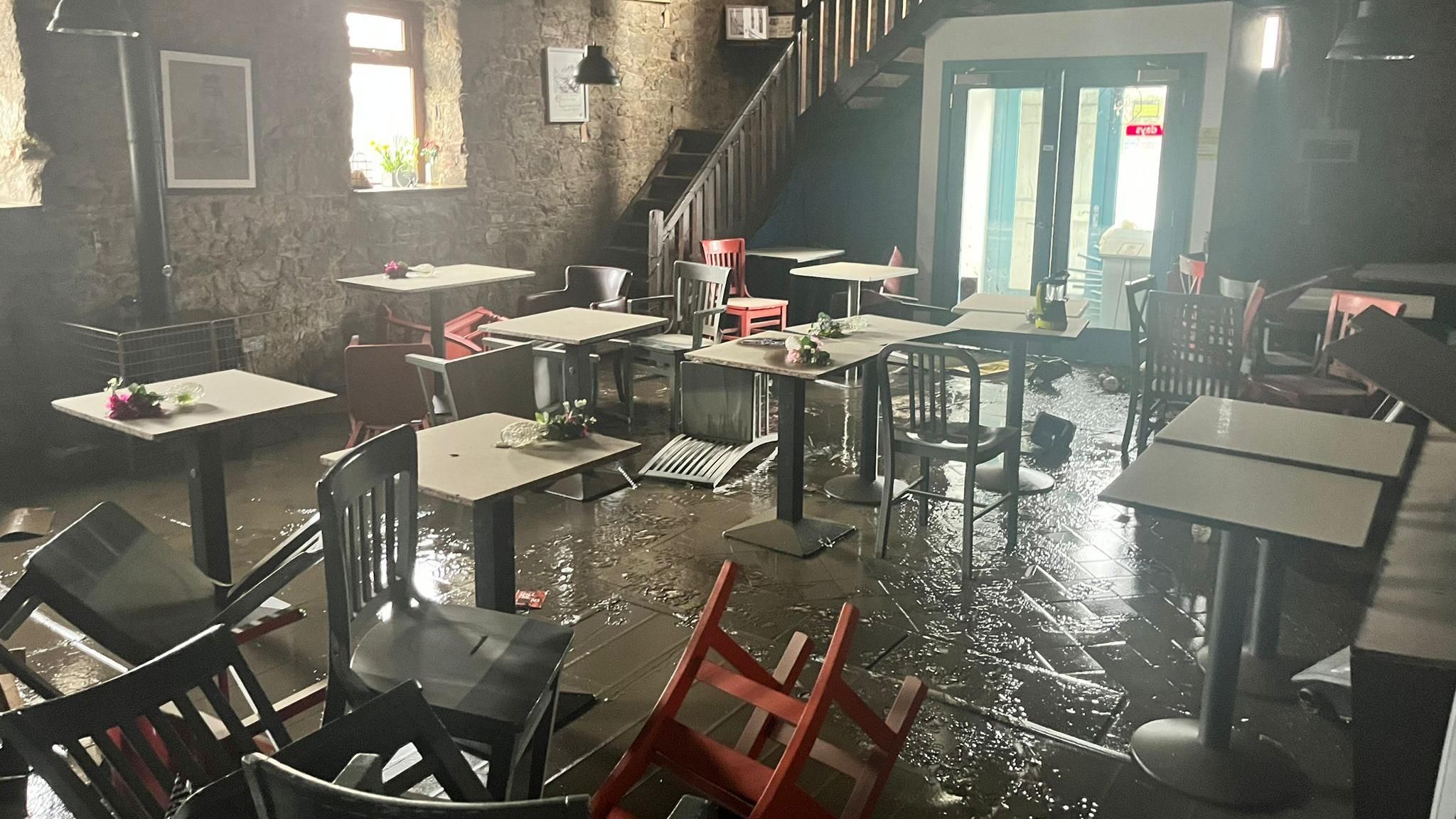 Floodwater and overturned furniture in Synge & Byrne's Newry cafe