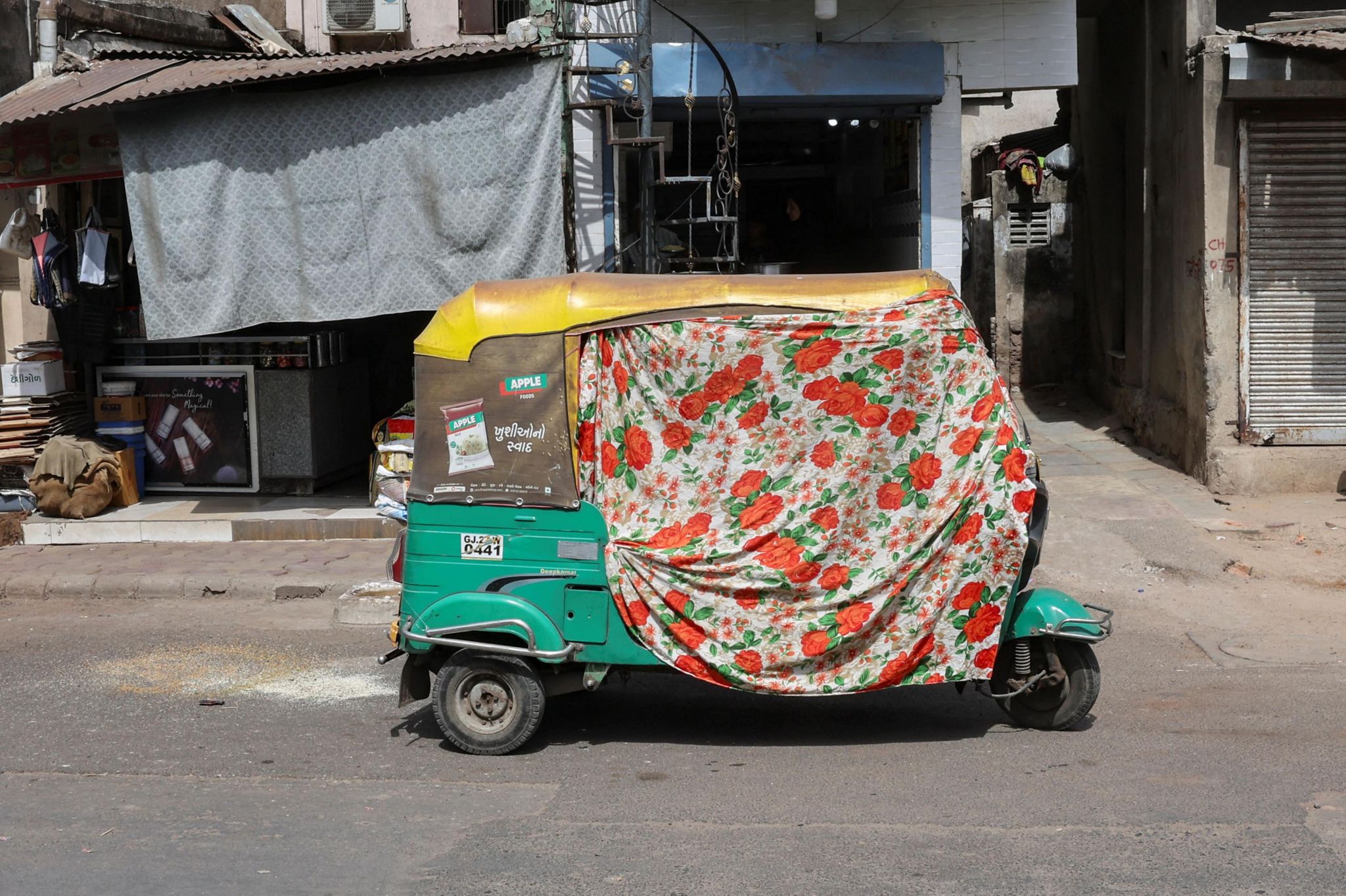 An autorickshaw covered with a cloth during a heat wave in Ahmedabad