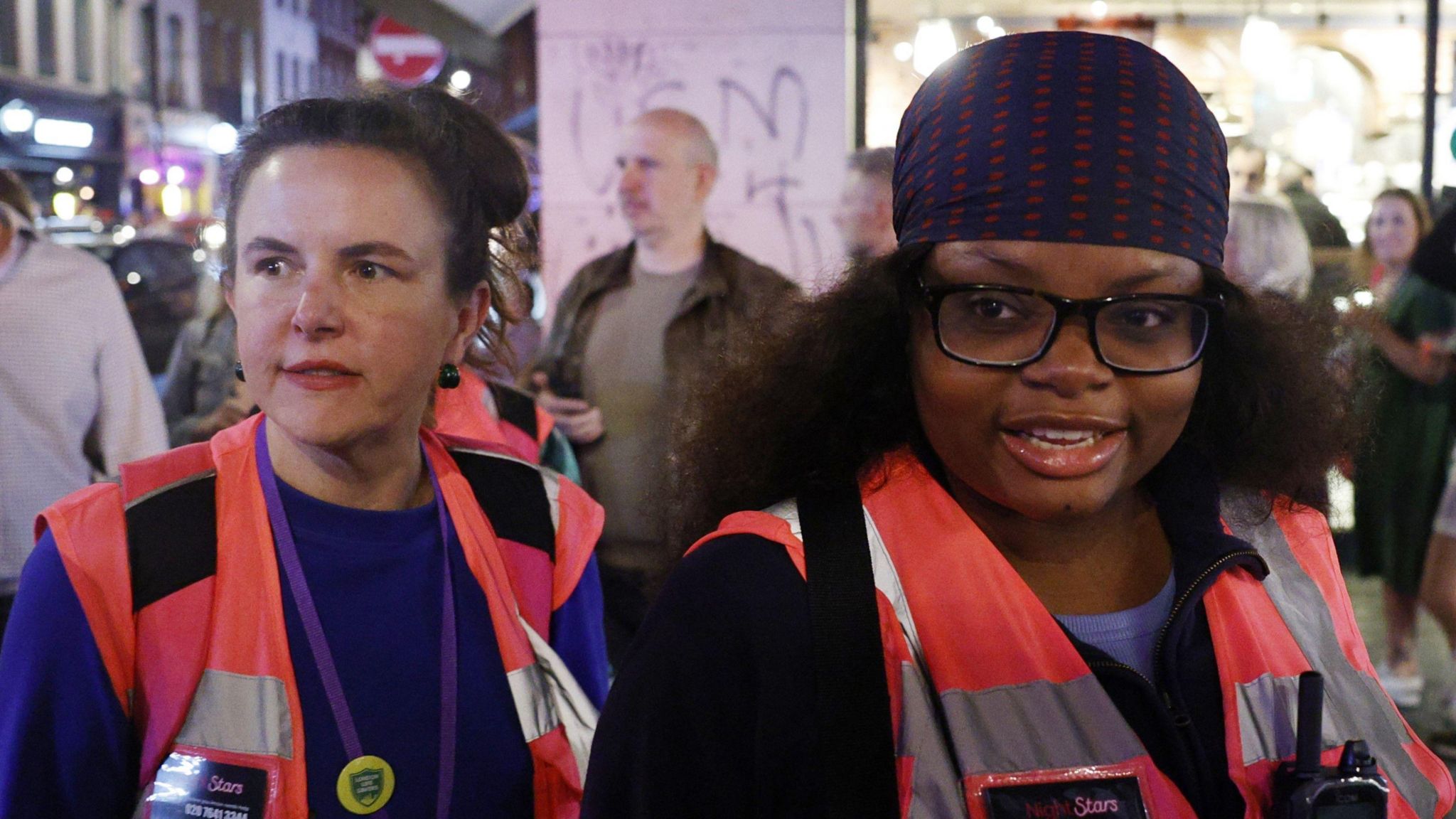 Rebecca Damm (left) and Emmanuella Fadire wearing their pink high vis Night Stars vests while patrolling Soho