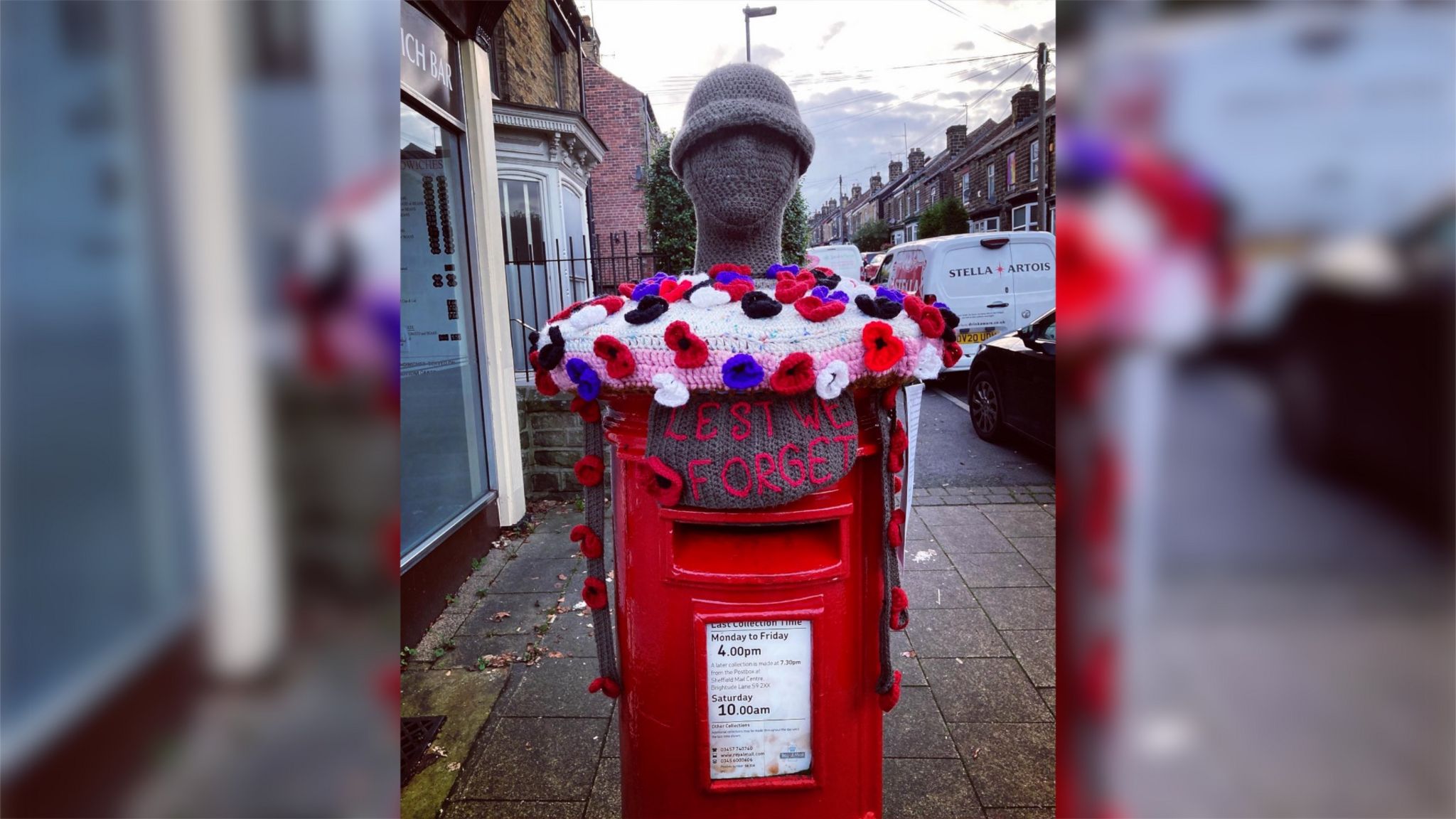 A postbox topper in Sheffield with different coloured poppies, including those focused on peace.