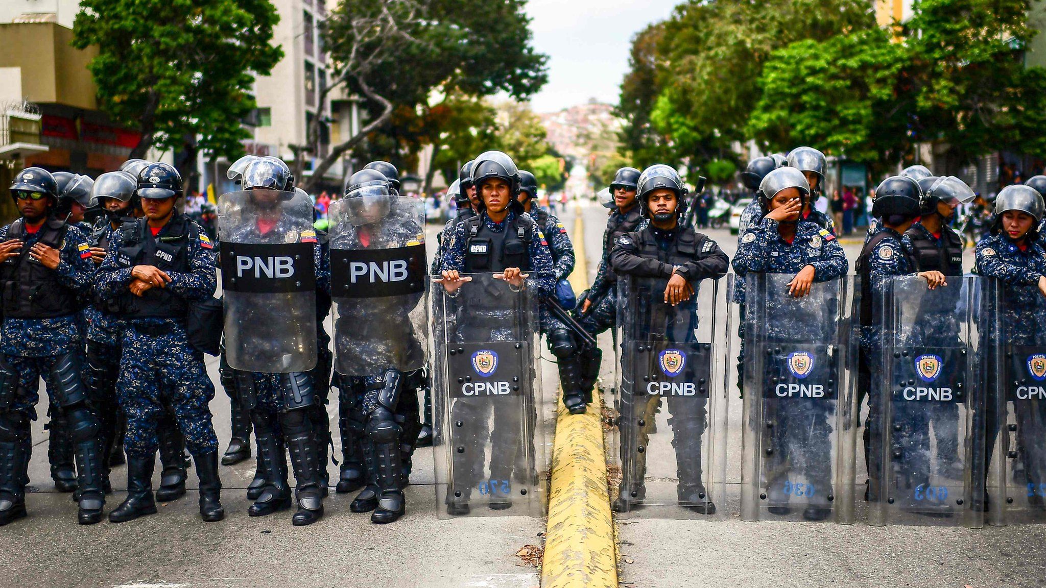 Venezuelan riot police block a street during a demo
