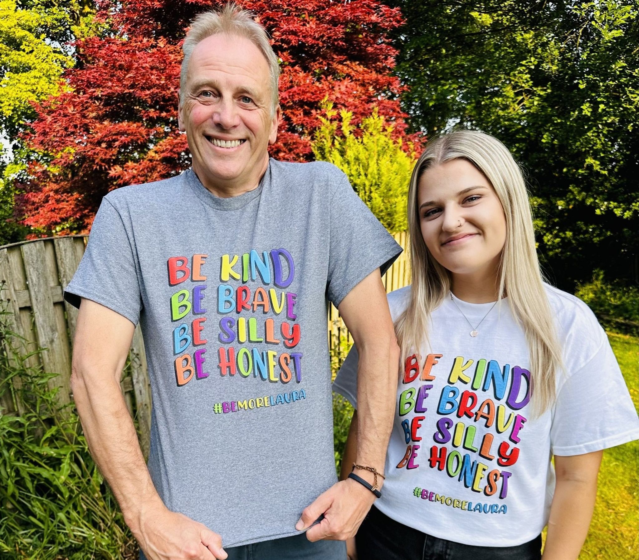 Gracie and her father wearing the T-shirts she designed