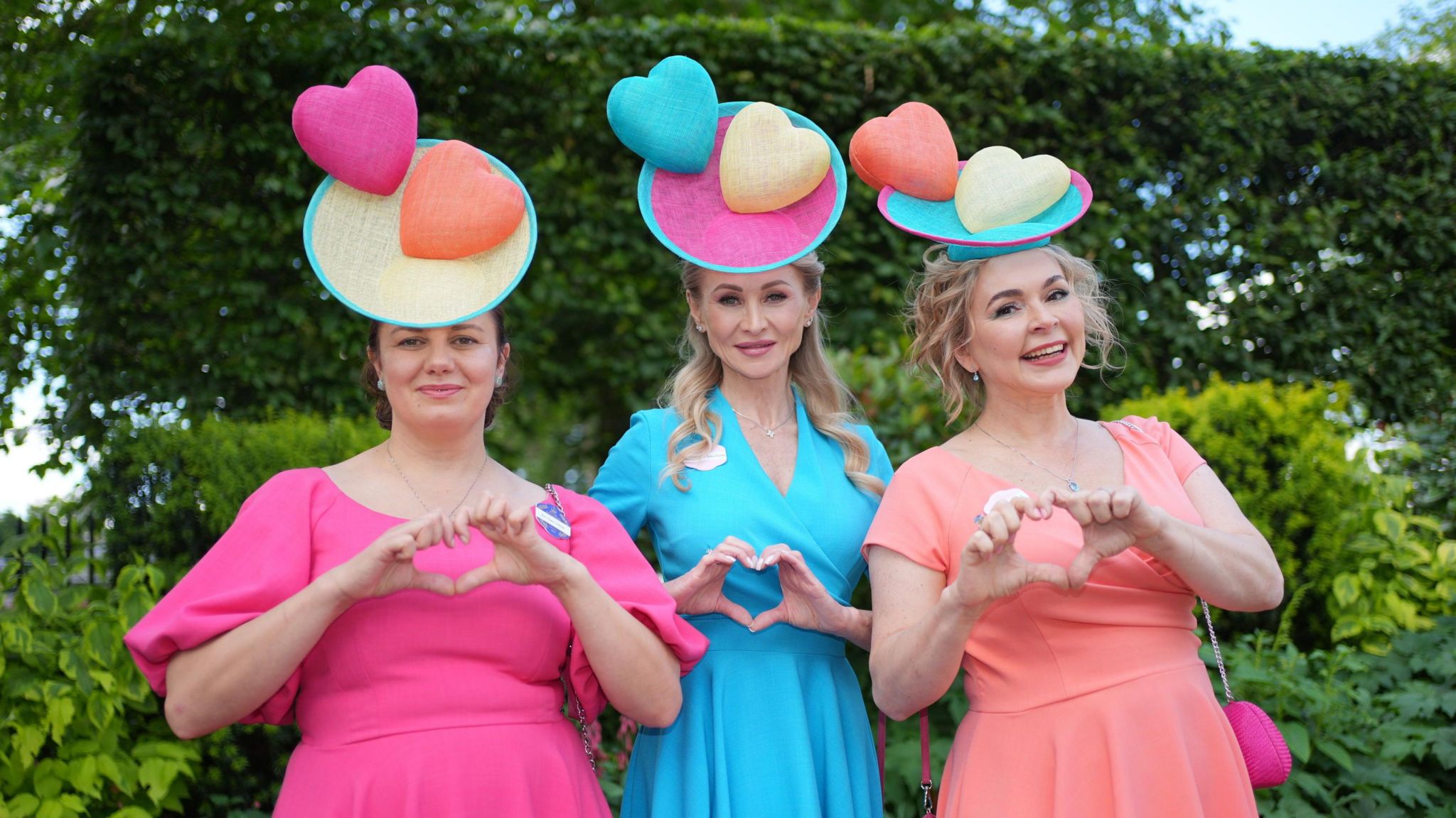Anna Gilder, Svetlana Krarchenko and Dr Elena Karnovitch pictured wearing candy-coloured loveheart-themed hats