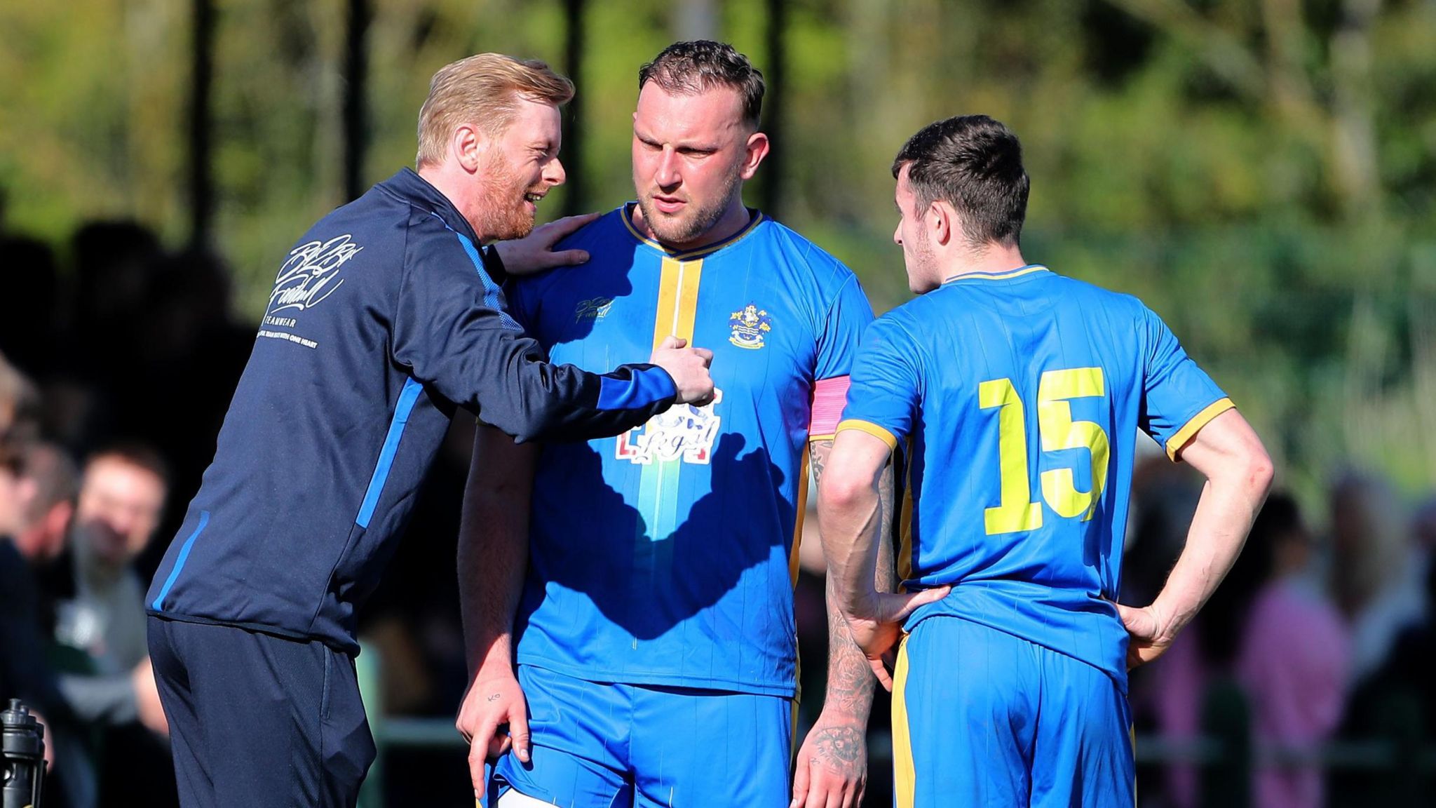 Dan Spinks, Romford manager, speaks to two players during their FA Vase semi-final against Lincoln United
