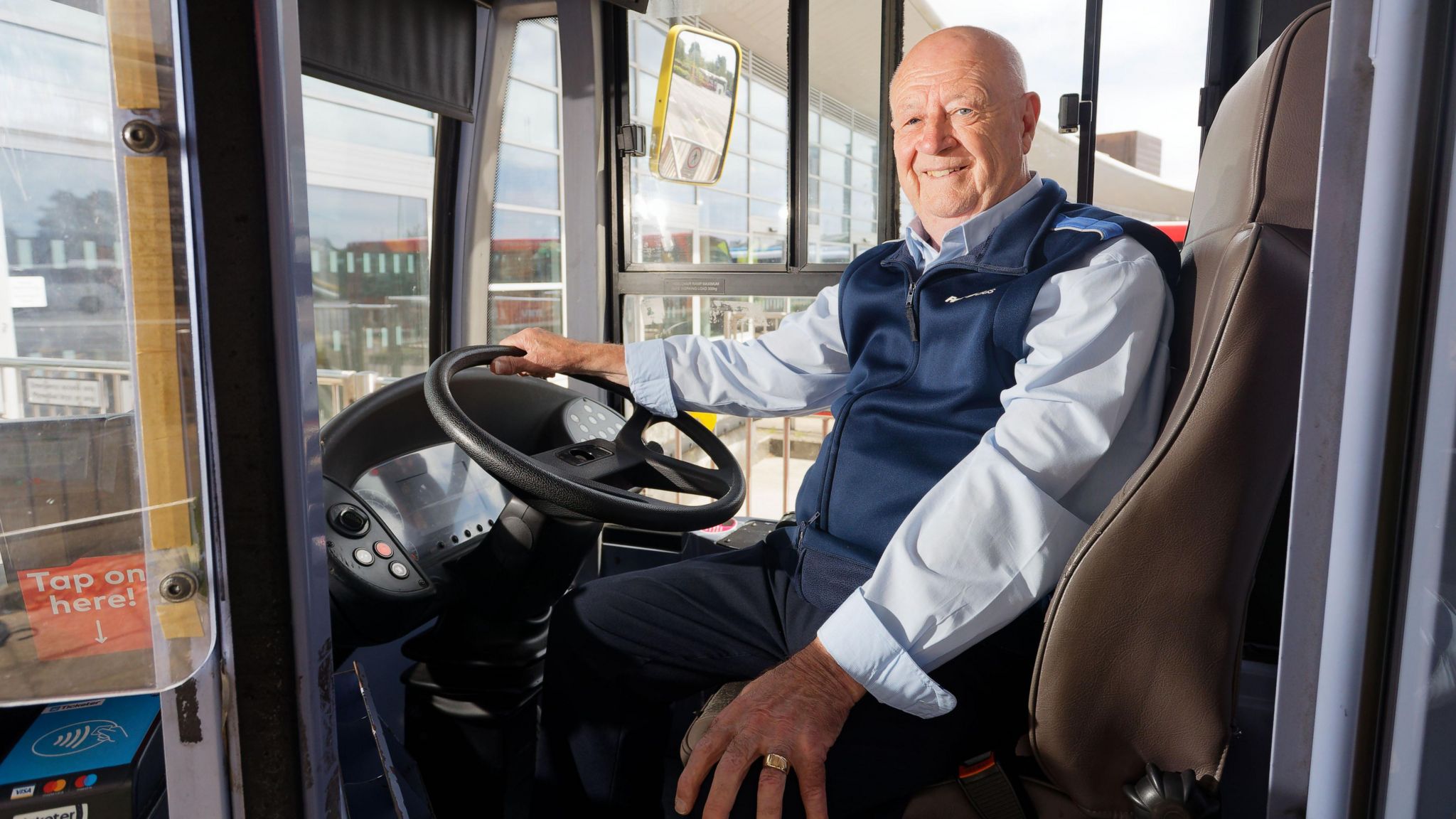 Kenny Beckers sat in the drivers seat on a bus