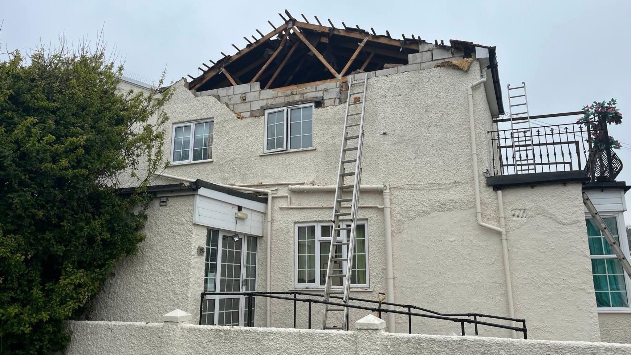 The damaged roof of a residential home in West Sussex after lightning strikes