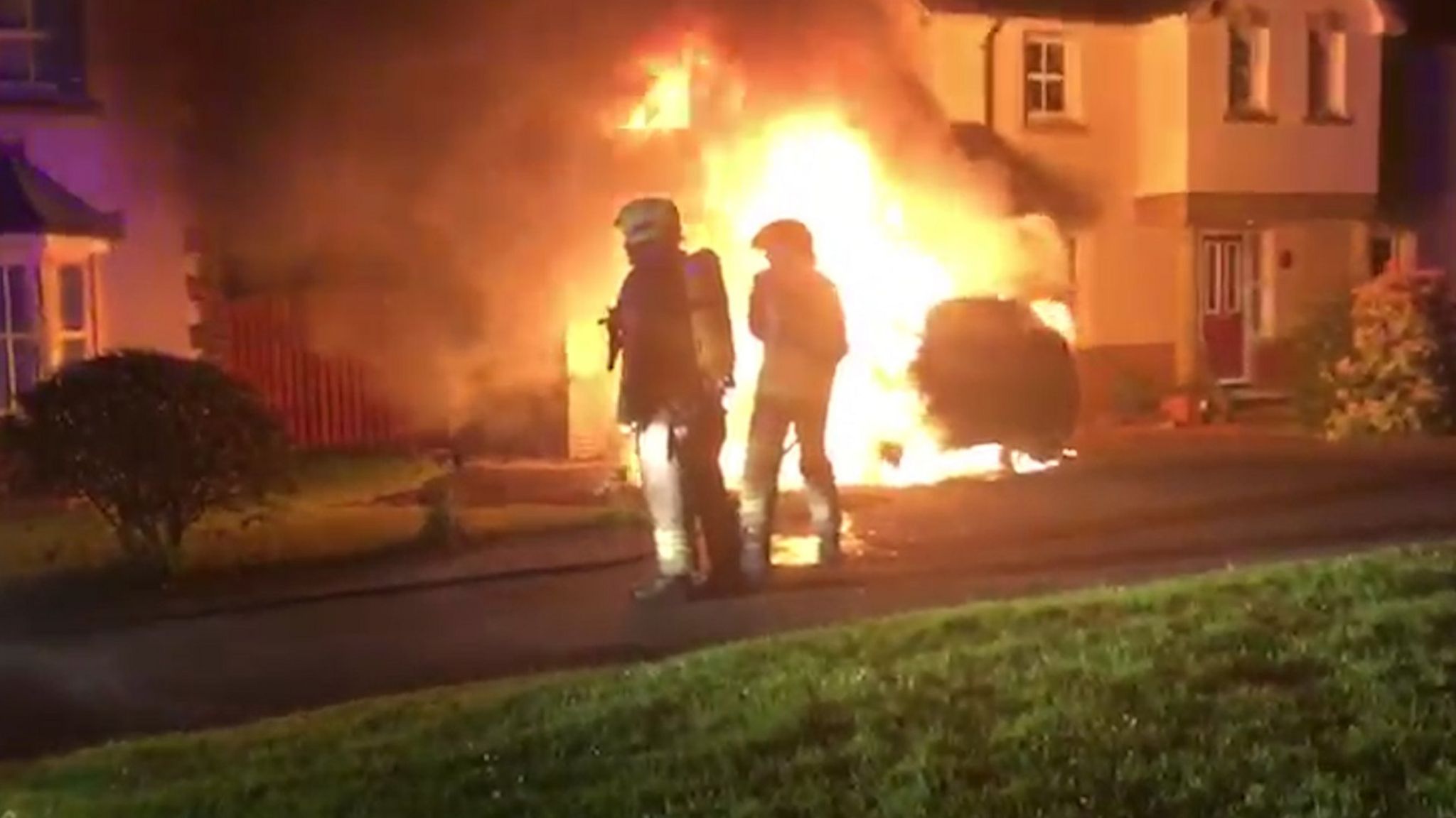 Firefighters tackling car fire