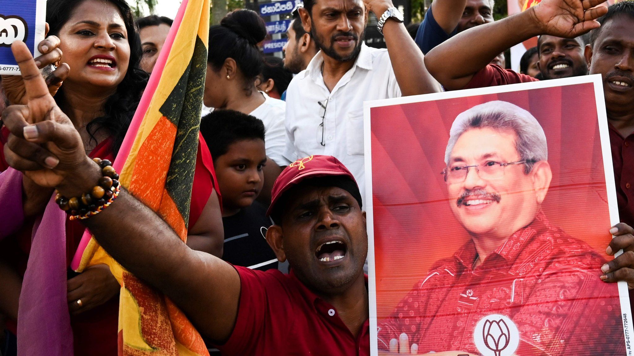 Supporters of Sri Lanka"s President-elect Gotabaya Rajapaksa shout slogans as he leaves the election commission office in Colombo on November 17, 2019.