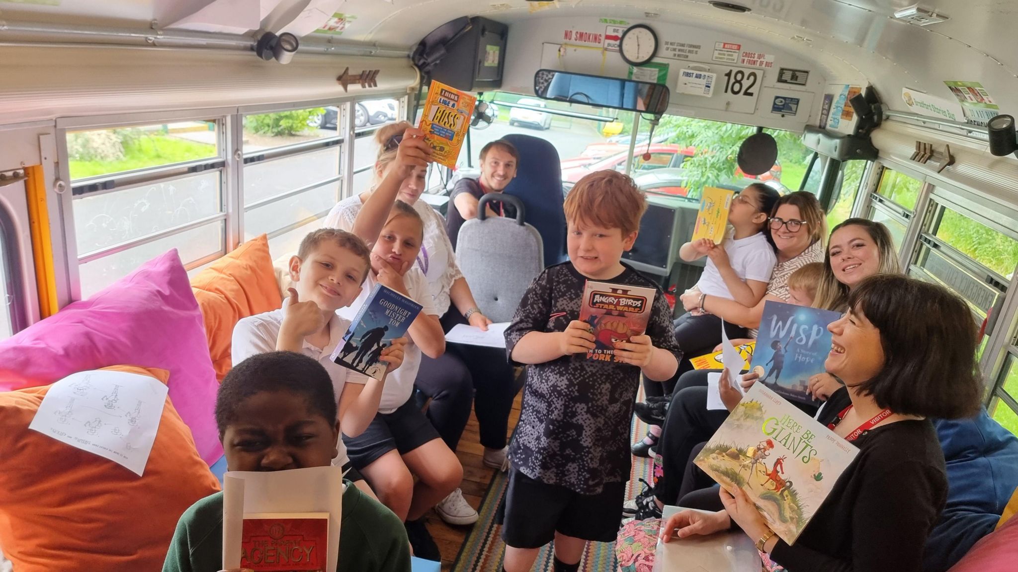 Children at Carrwood Primary in Homewood, Bradford are among 32 schools to have received new library facilities via the National Literacy Trust's campaign. They are pictured here aboard the Bradford Stories Bus.