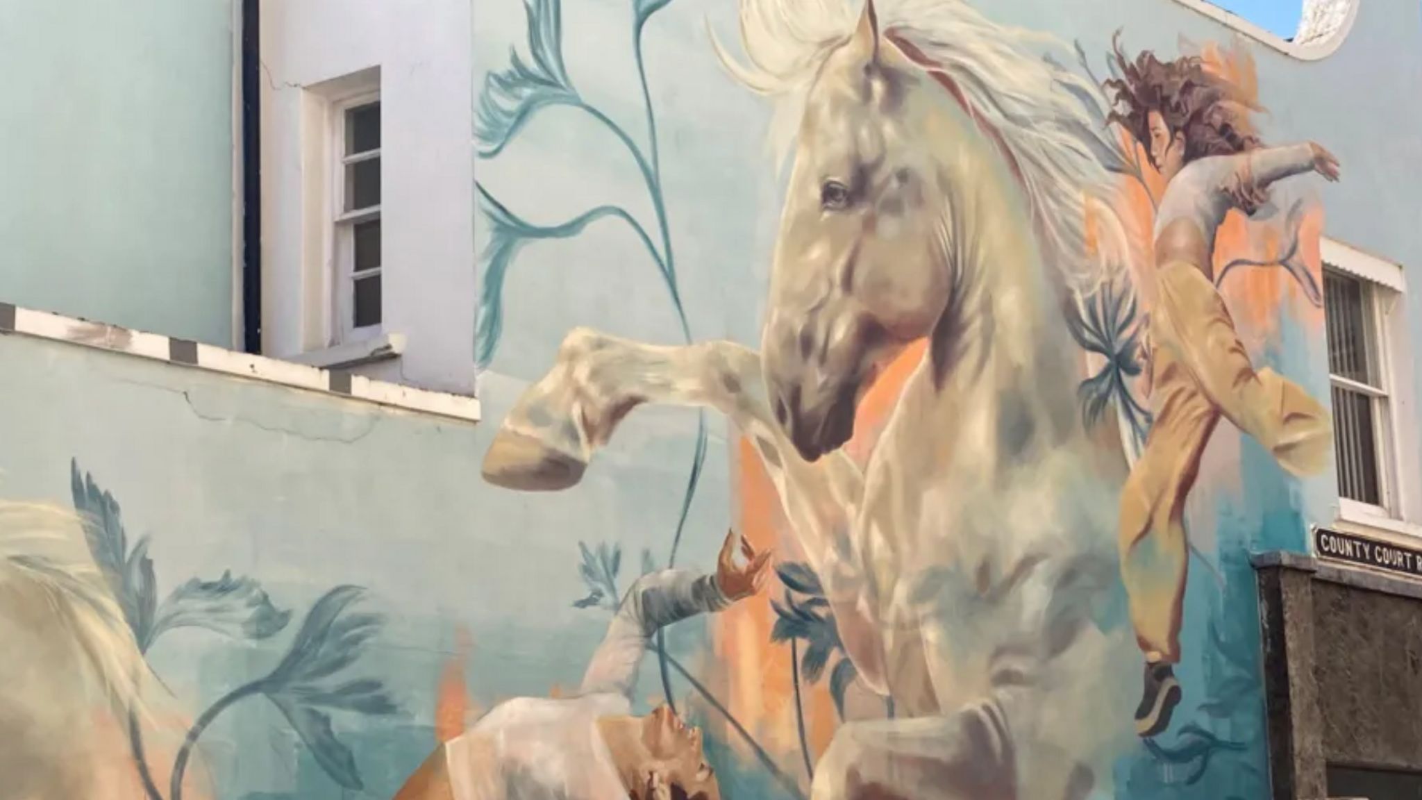 The horse mural on the side of the building