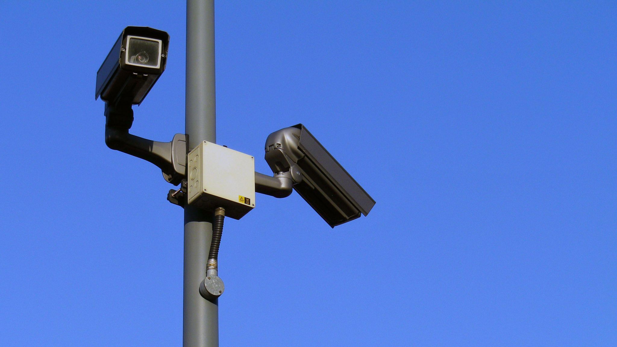 Two CCTV cameras mounted to a lamppost