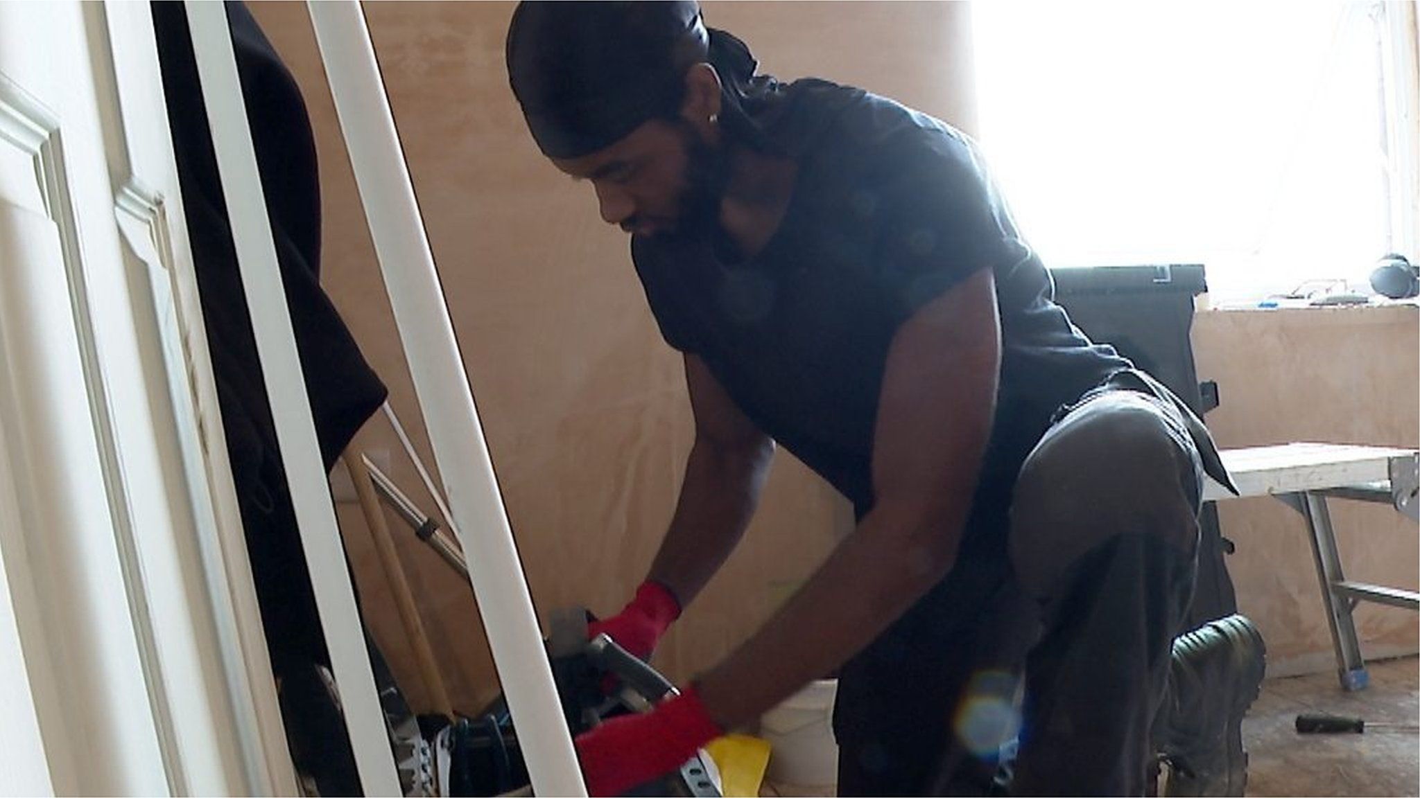 A man doing building work in a house