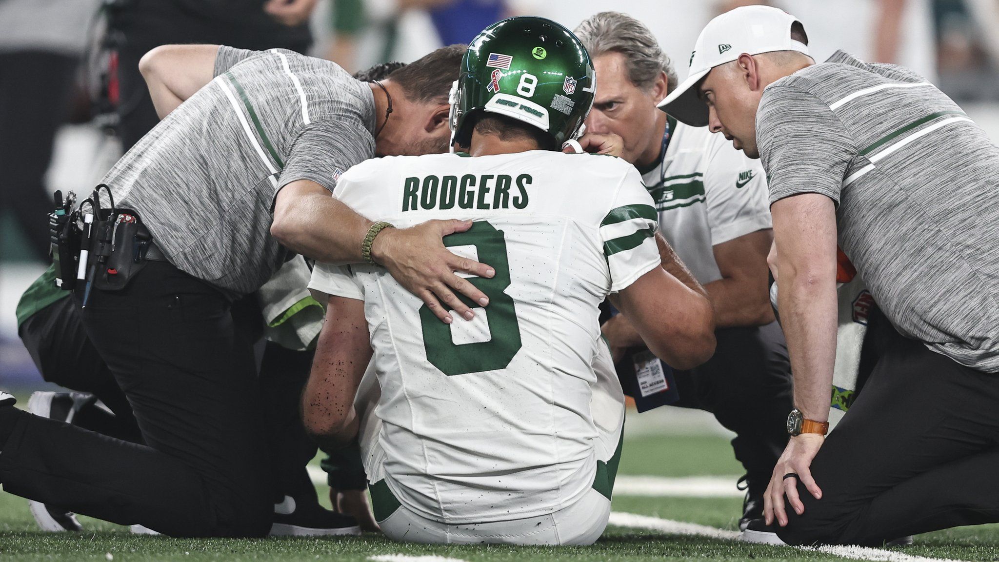 Aaron Rodgers #8 of the New York Jets is looked at by the medical staff