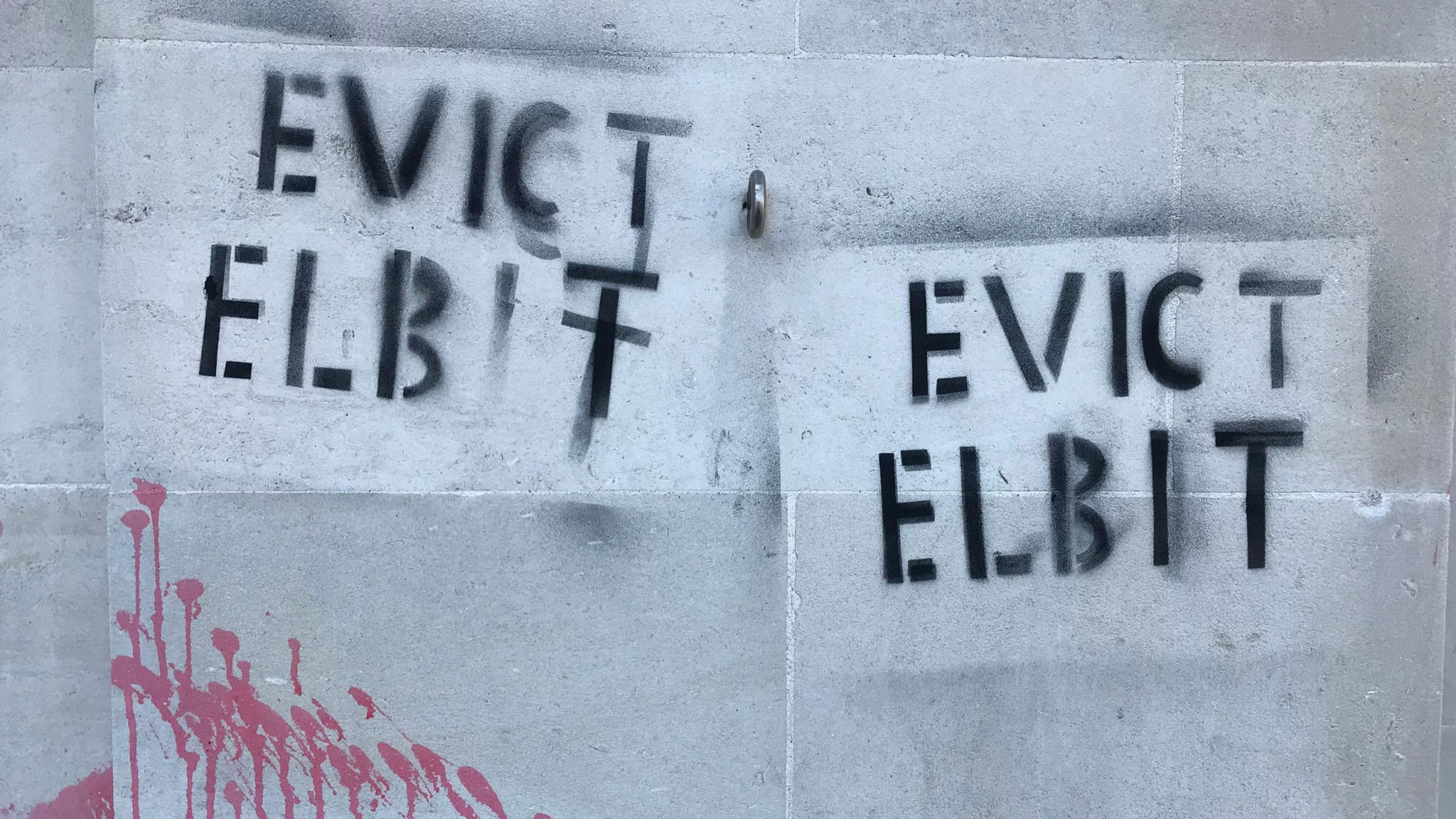 The words 'Evict Elbit' sprayed on the side of Somerset Council's building
