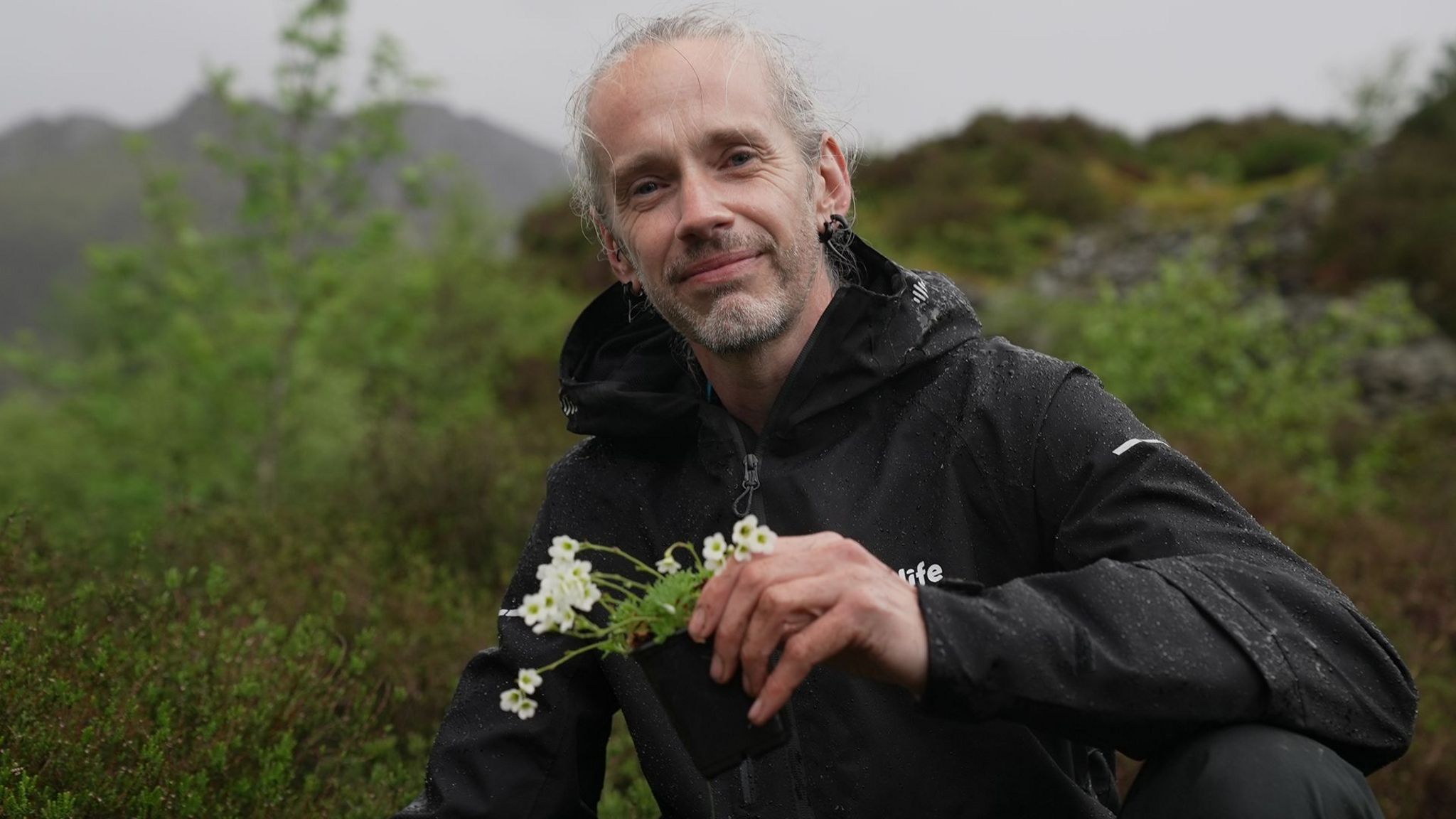 Robbie Blackhall-Miles holding the rosy saxifrage