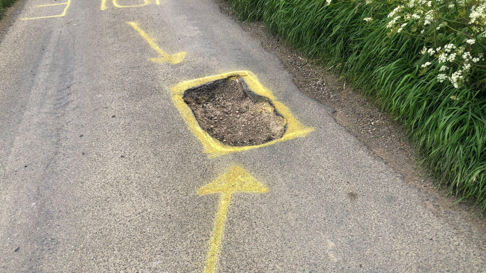 Pothole with yellow paint