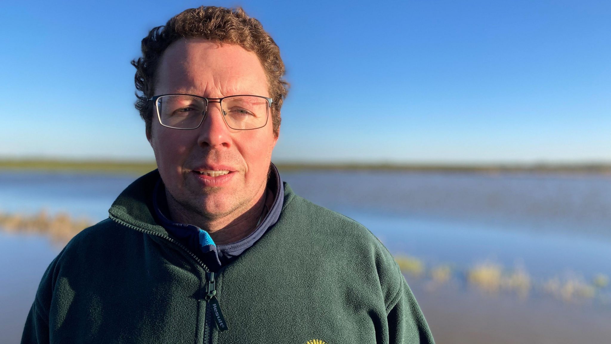 Farmer William Tyrrell standing in front of his flooded fields