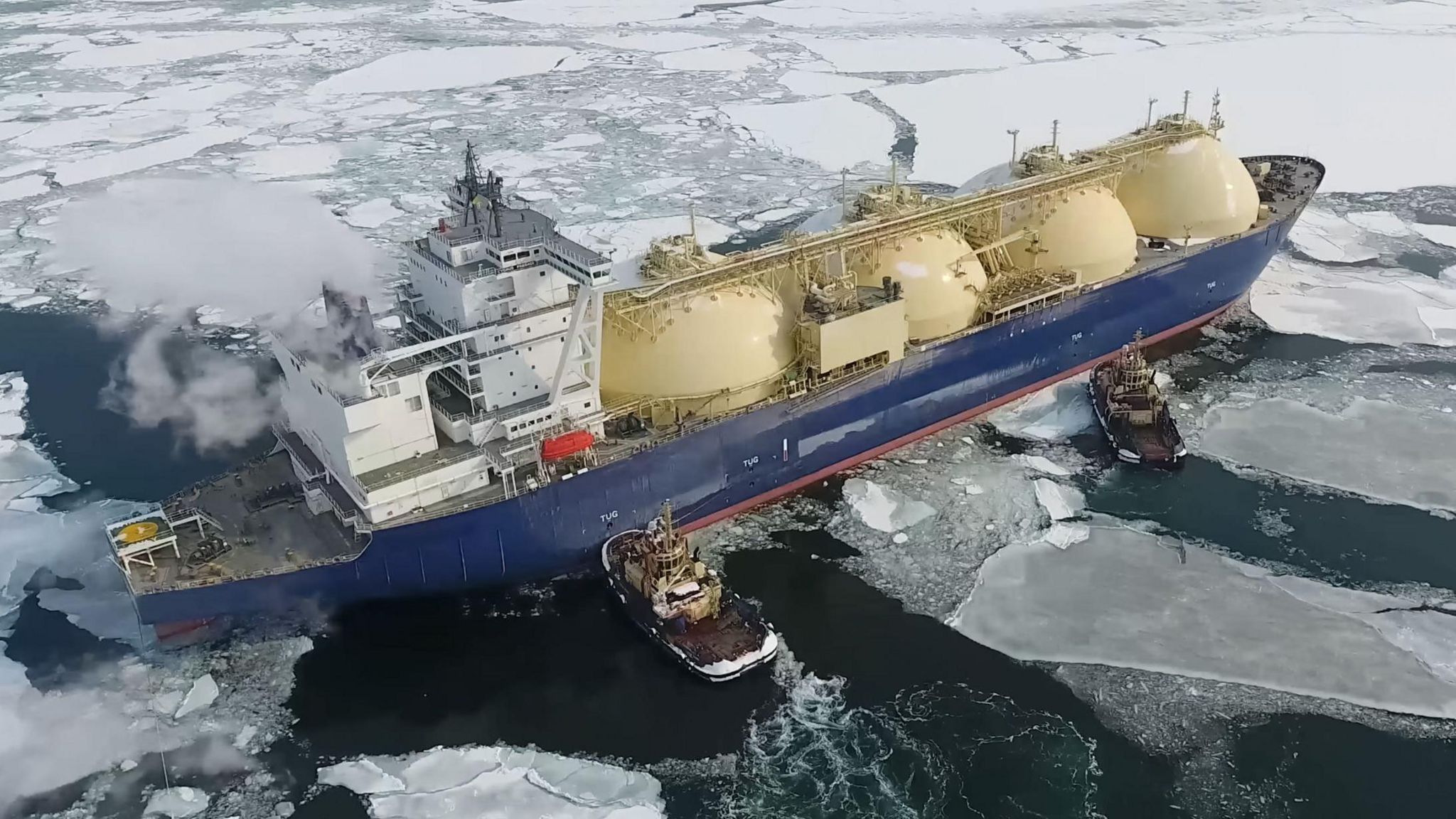 A ship in Arctic waters powered by tug boats