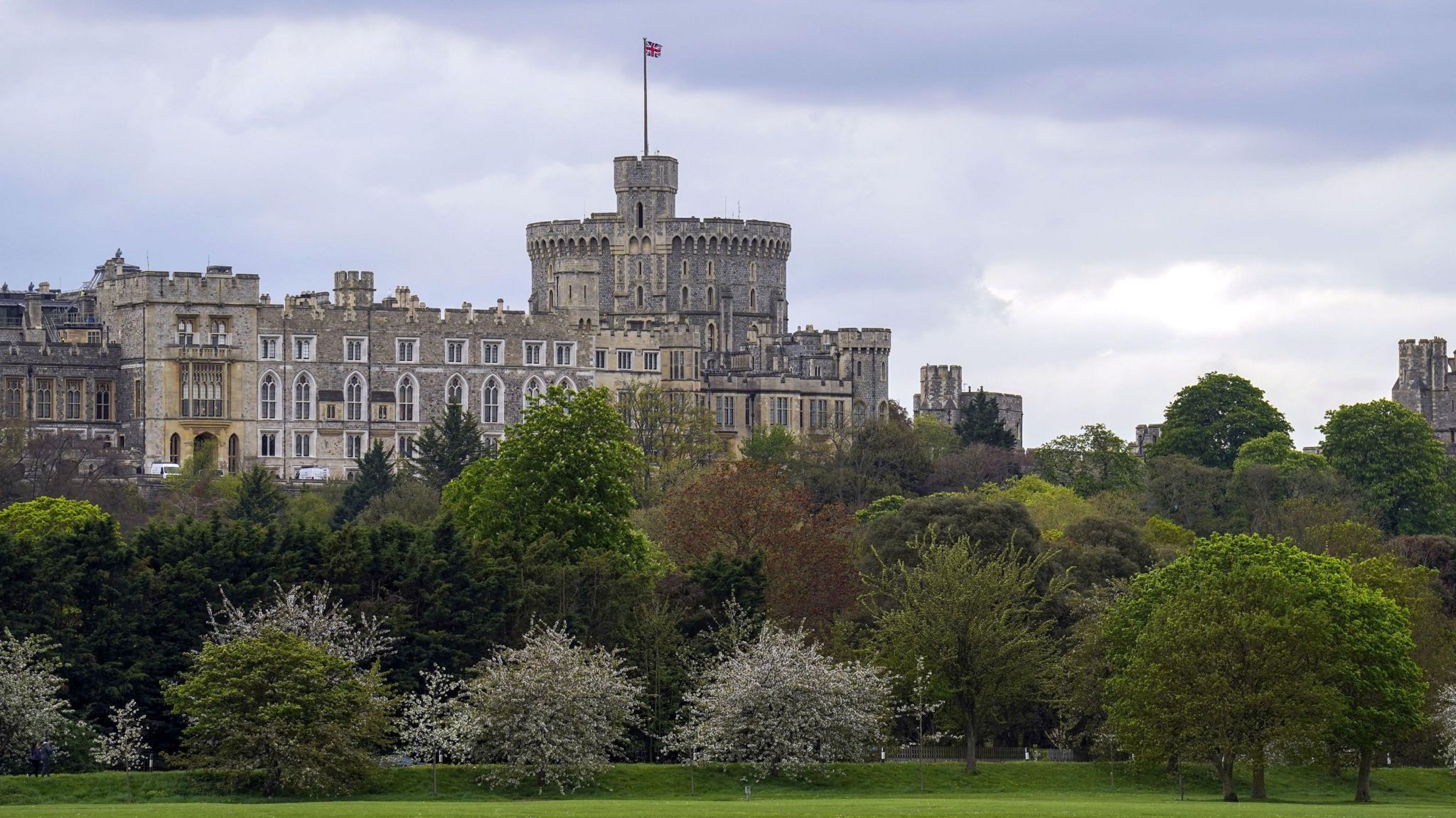 Windsor Castle exterior with trees and a field in front of it