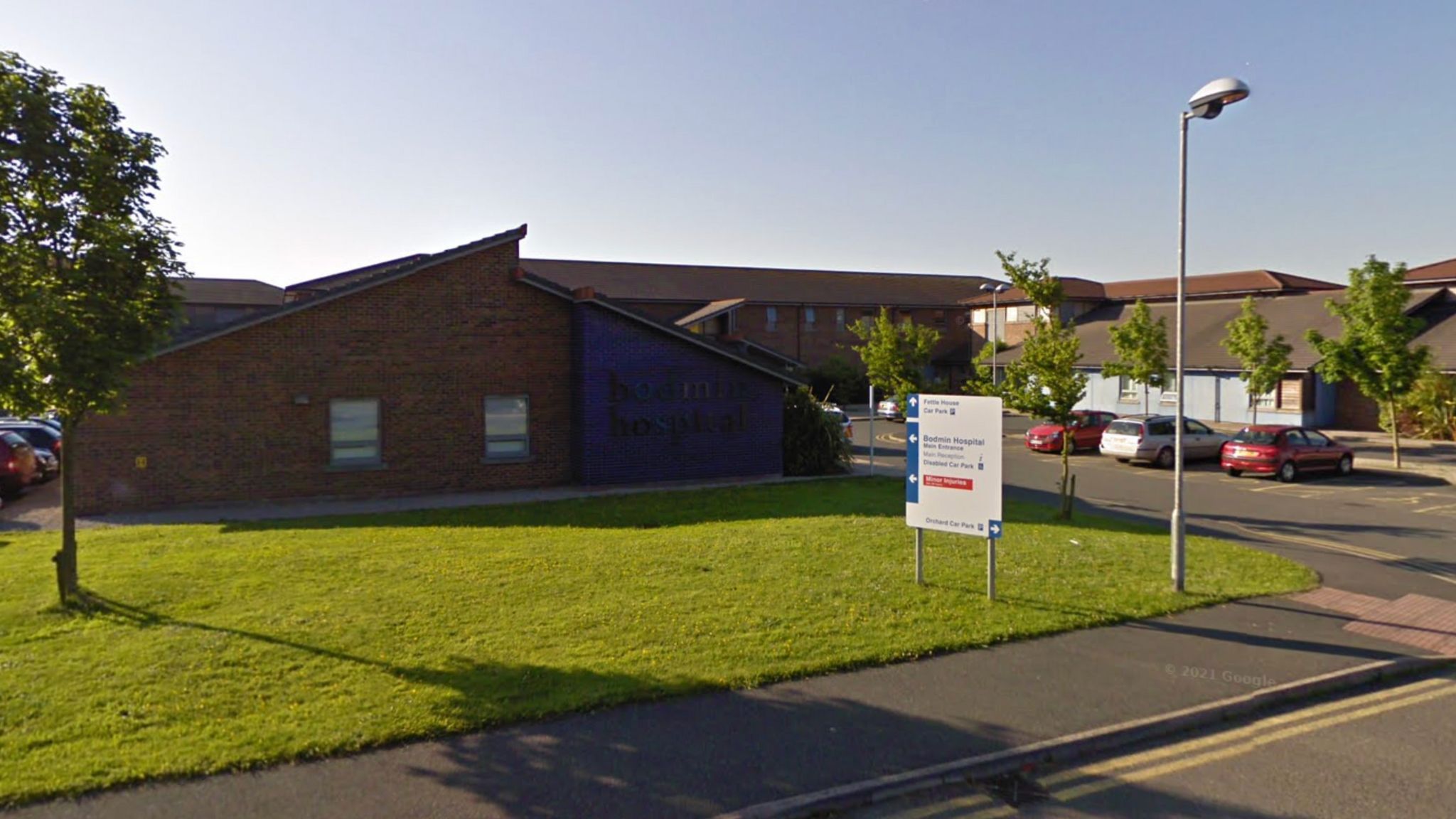 Entrance to Bodmin Community hospital, near car park and green lawn.