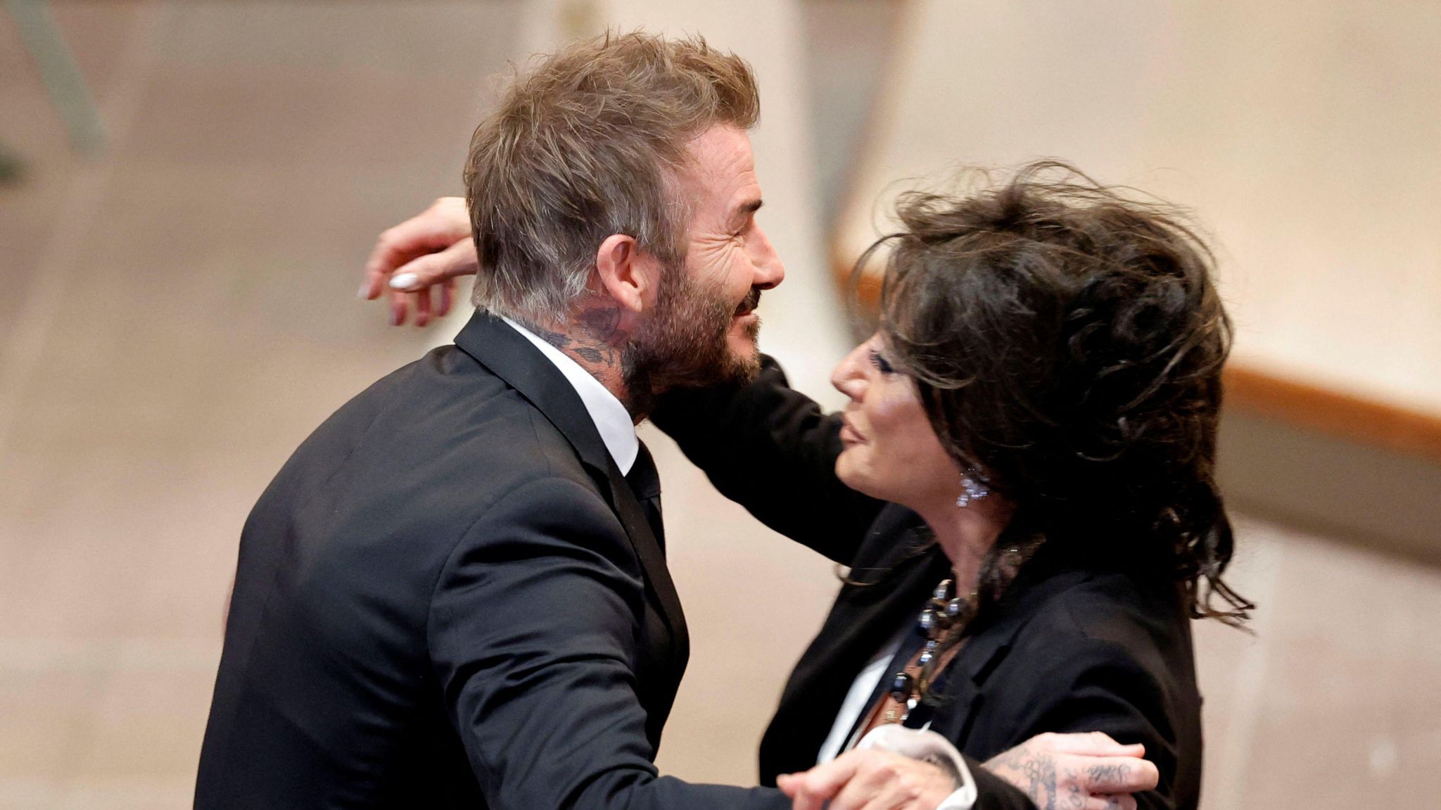 Sven-Goran Eriksson's former partner Nancy Dell'Olio (right) hugs David Beckham