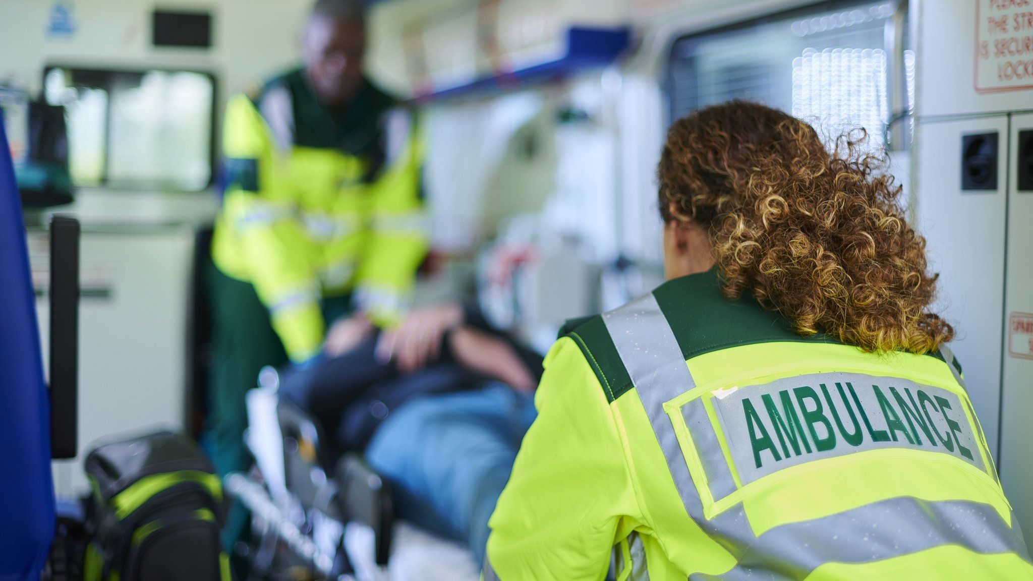 Paramedics with a patient in an ambulance