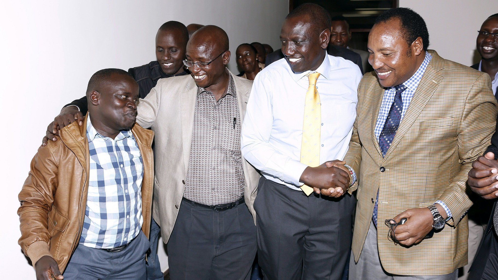 A handout picture taken and released on 5 April 2016 by the Deputy President's Office shows Kenya's Deputy President William Ruto (2nd R) celebrating in Nairobi with Joshua arup Sang (L) shortly after charges of crimes against humanity against them were dropped by the ICC