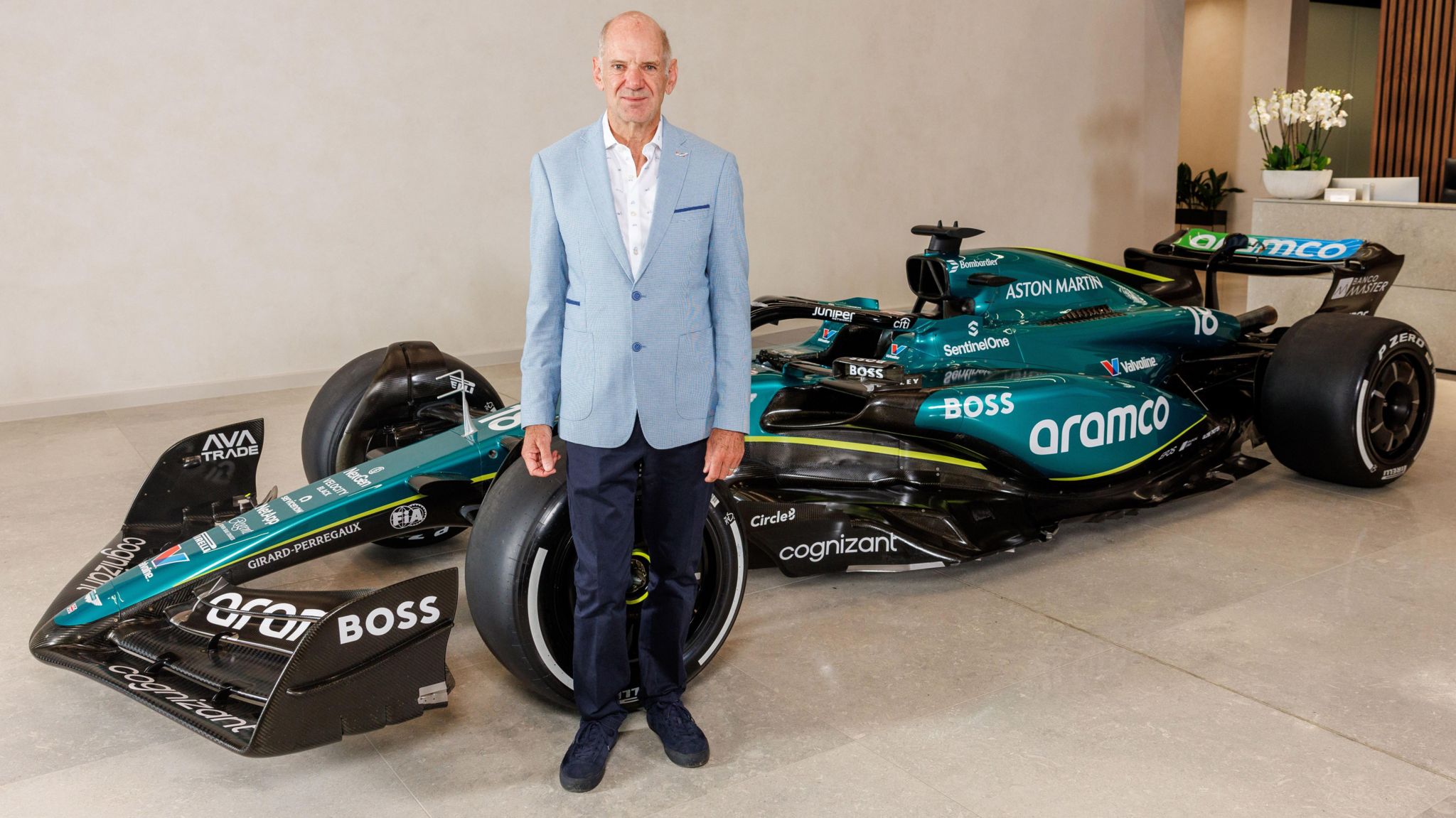 Adrian Newey stands in front of an Aston Martin Formula 1 car 