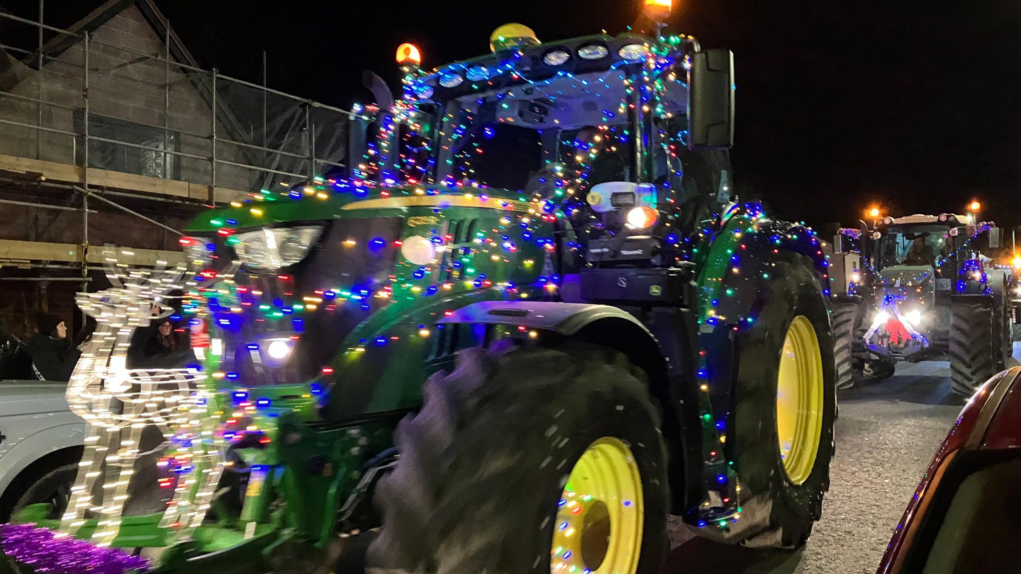 Tractor decorated with festive lights for a charity paade