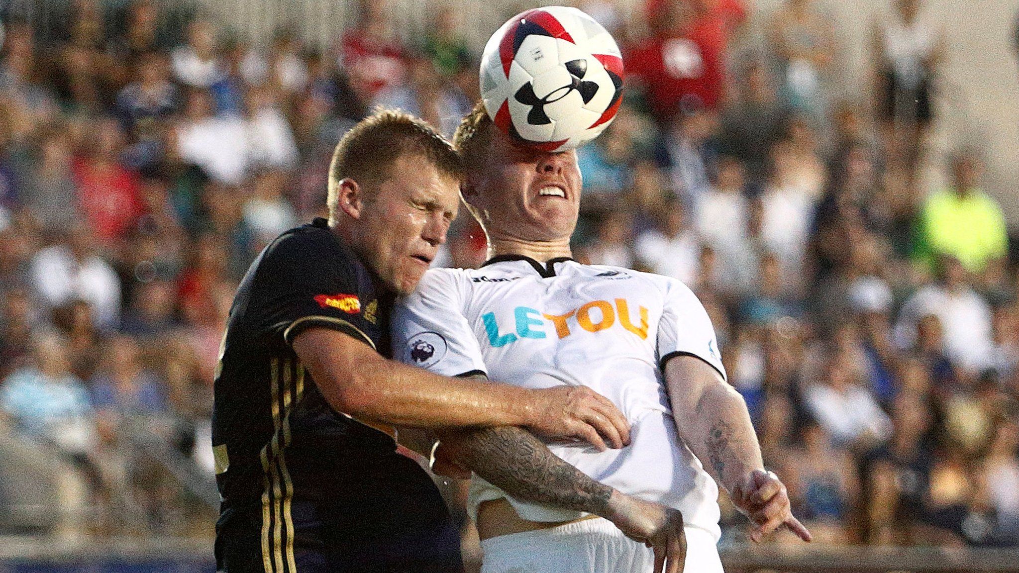 Swansea City's Alfie Mawson in action with North Carolina's Brad Ruhaak