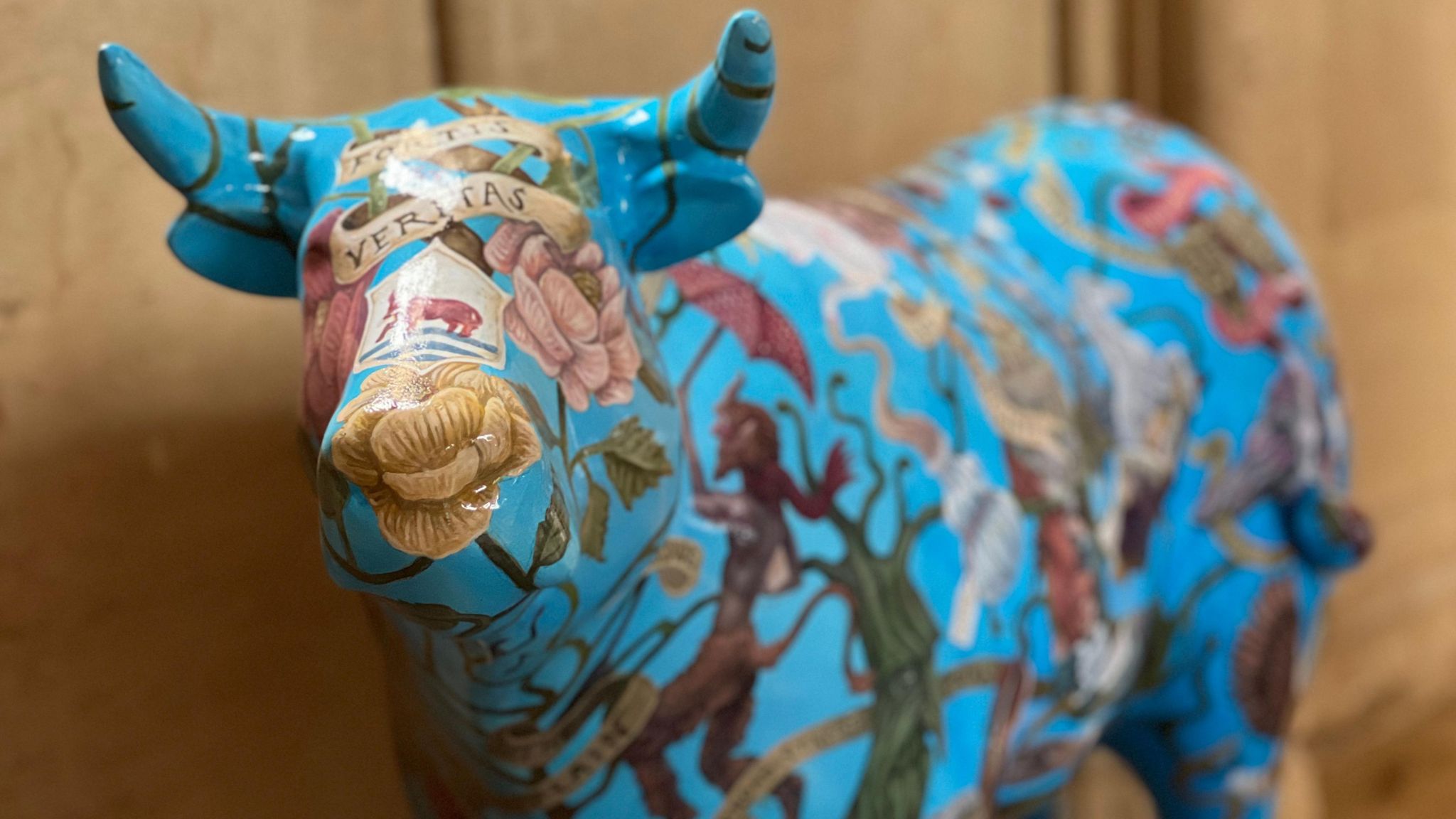 A light blue ox sculpture with patterns across it