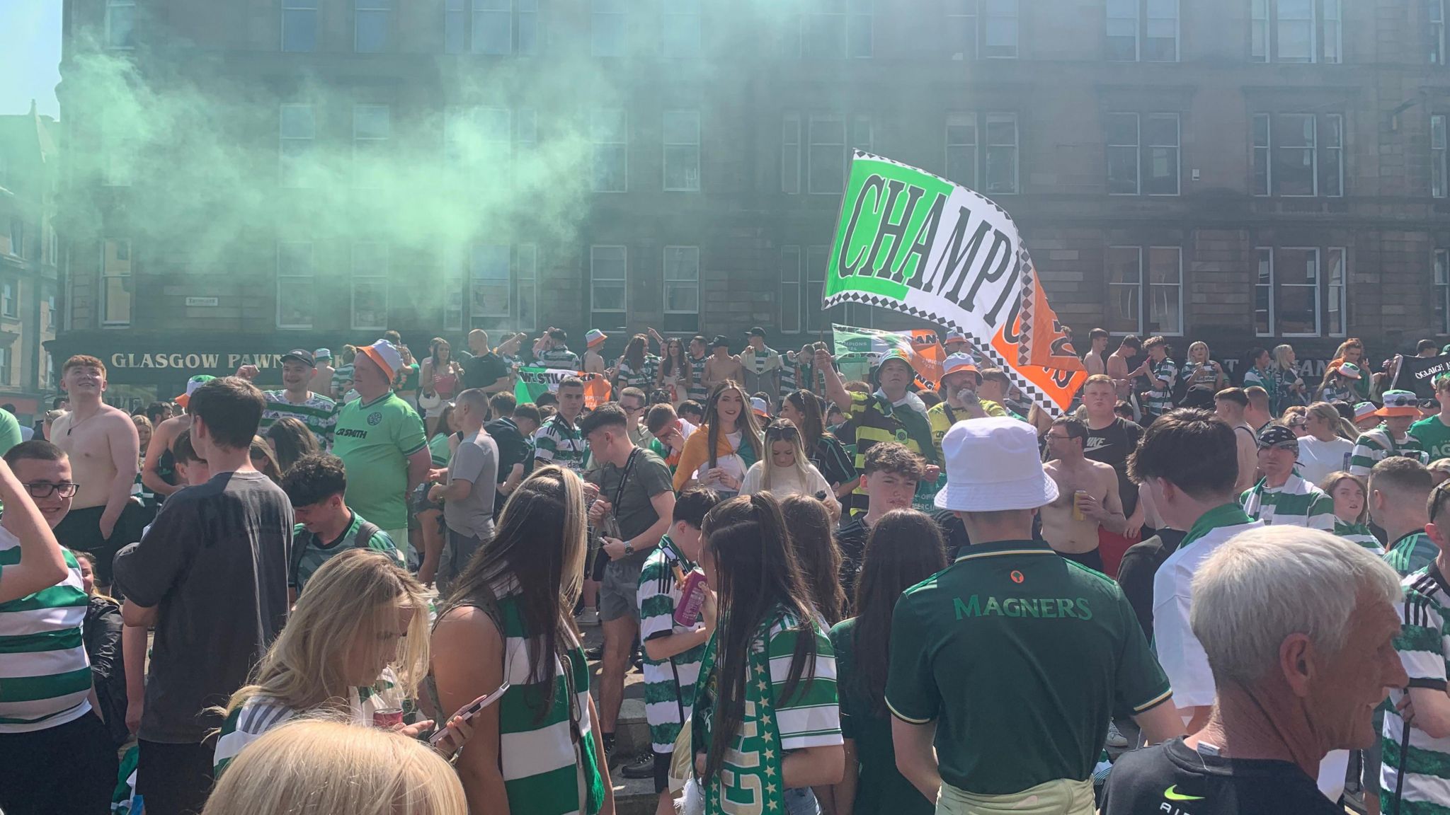 Celtic fans waving flags and banners in Glasgow