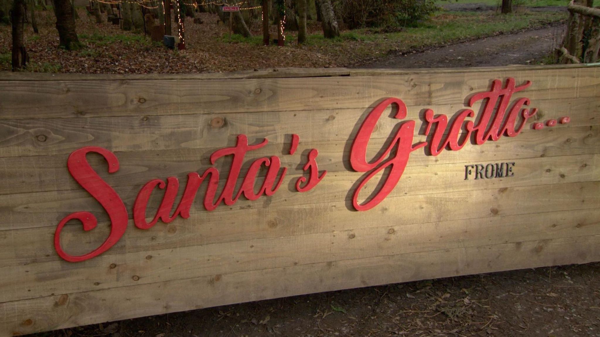 Santa's Grotto in red lettering on wood background