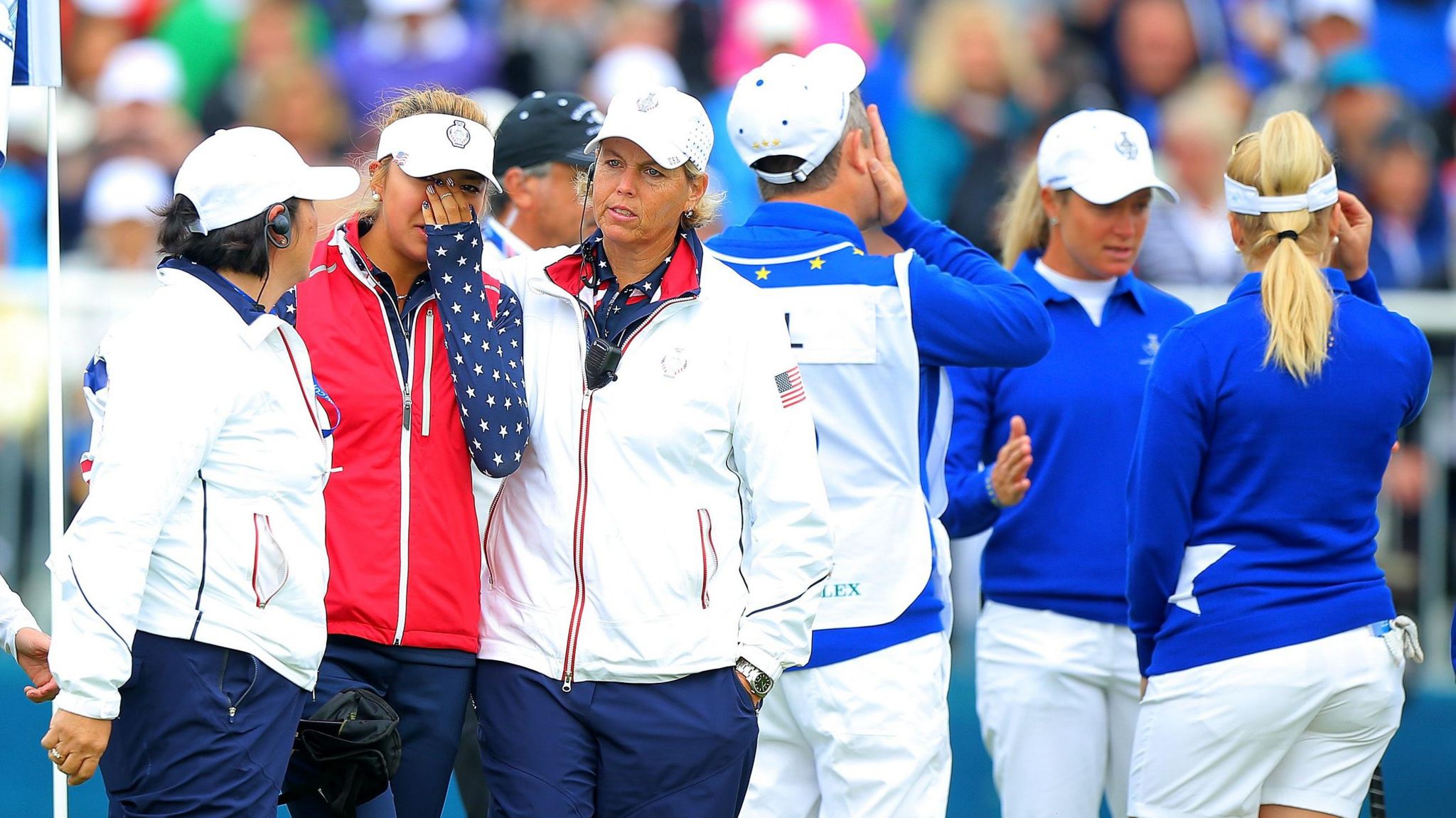 American player Alison Lee is comforted by her team-mates, while Suzann Pettersen (right) showed the length of putt she had not conceded during their controversial match in 2015