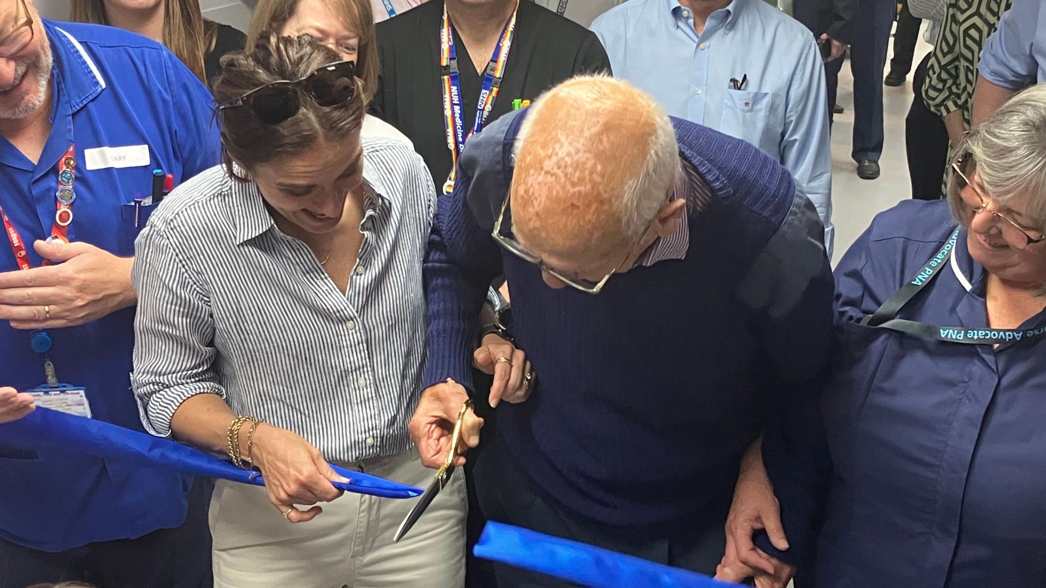 Vicky McClure and 94-year-old patient Stanley Metcalf cutting a blue ribbon 