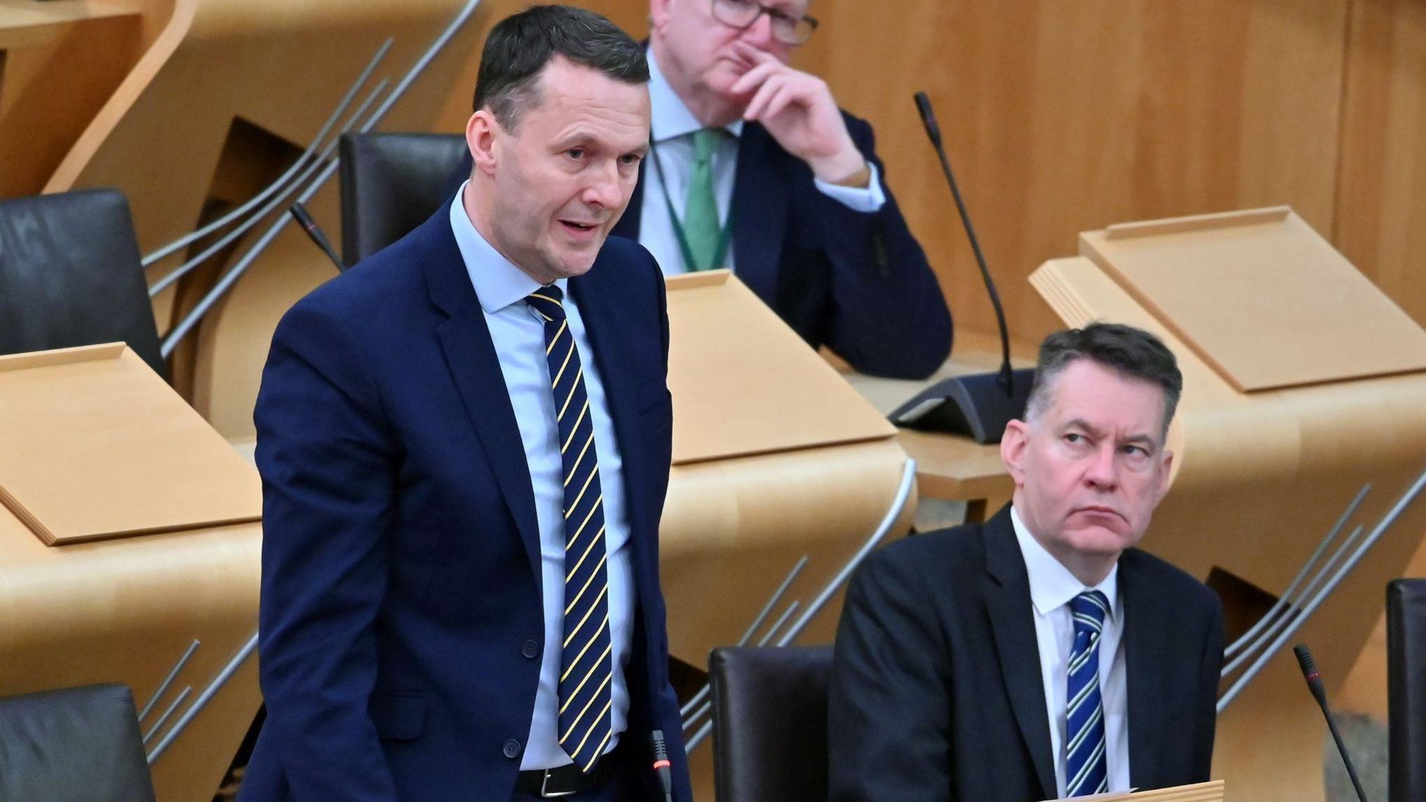 Russell Findlay speaks at Holyrood while Murdo Fraser watches on.